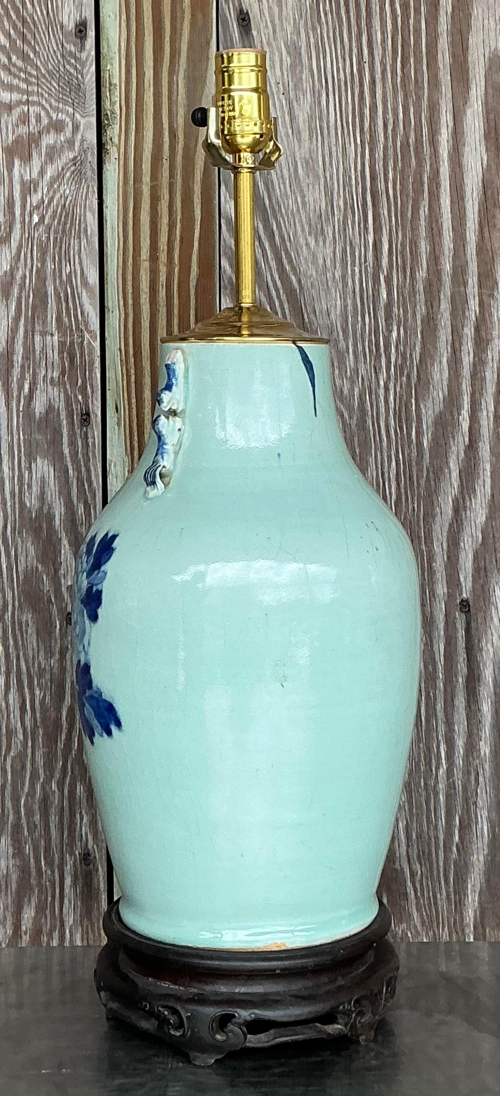 This vintage 19th-century Asian blue and white rooster lamp beautifully combines American appreciation for antique Asian art with functional decor. Featuring intricate blue and white detailing, the lamp showcases a classic rooster motif, adding