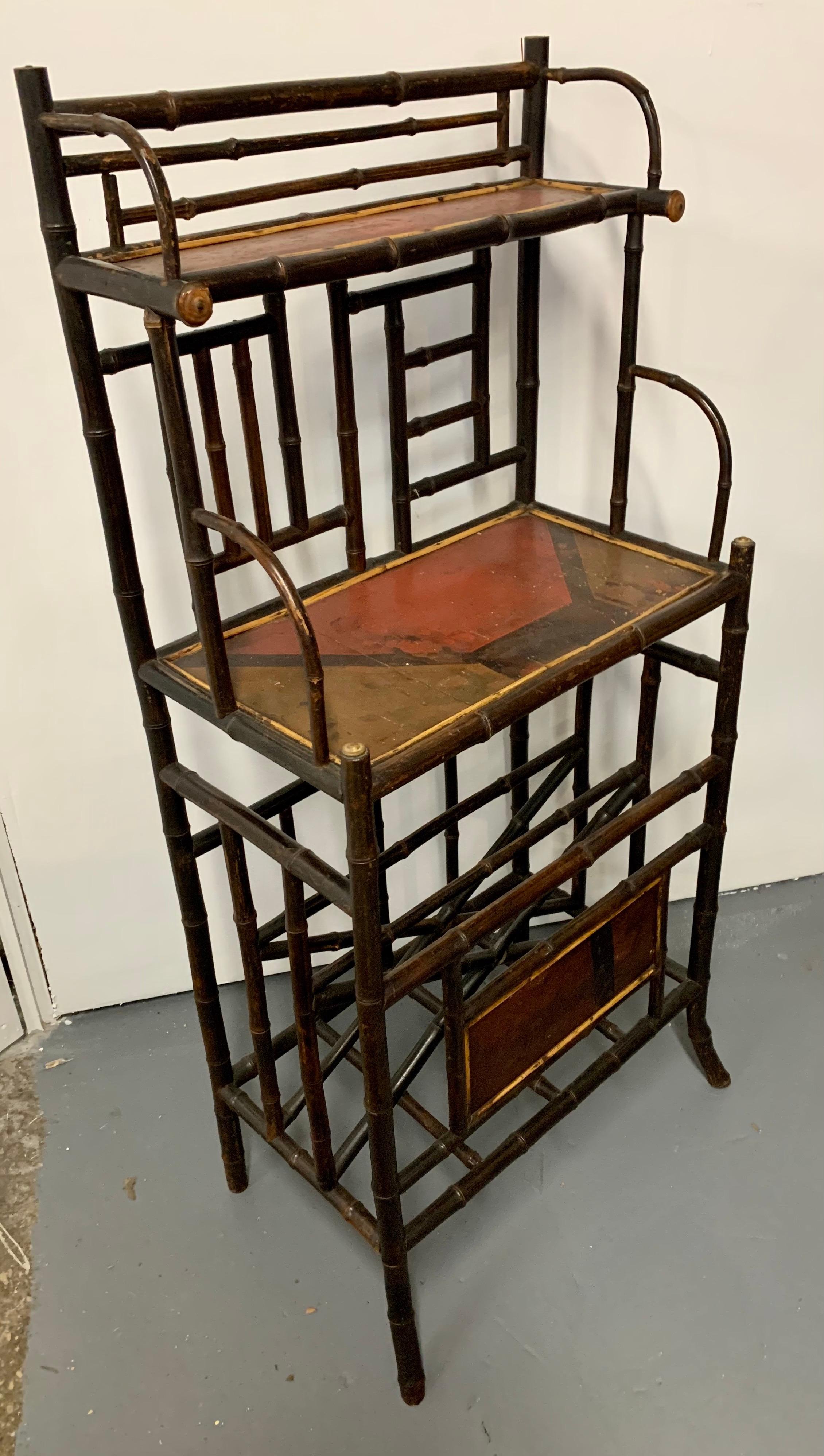 Antique bamboo etagere with painted shelves and front. Bottom portion has rack to hold newspapers or magazines.