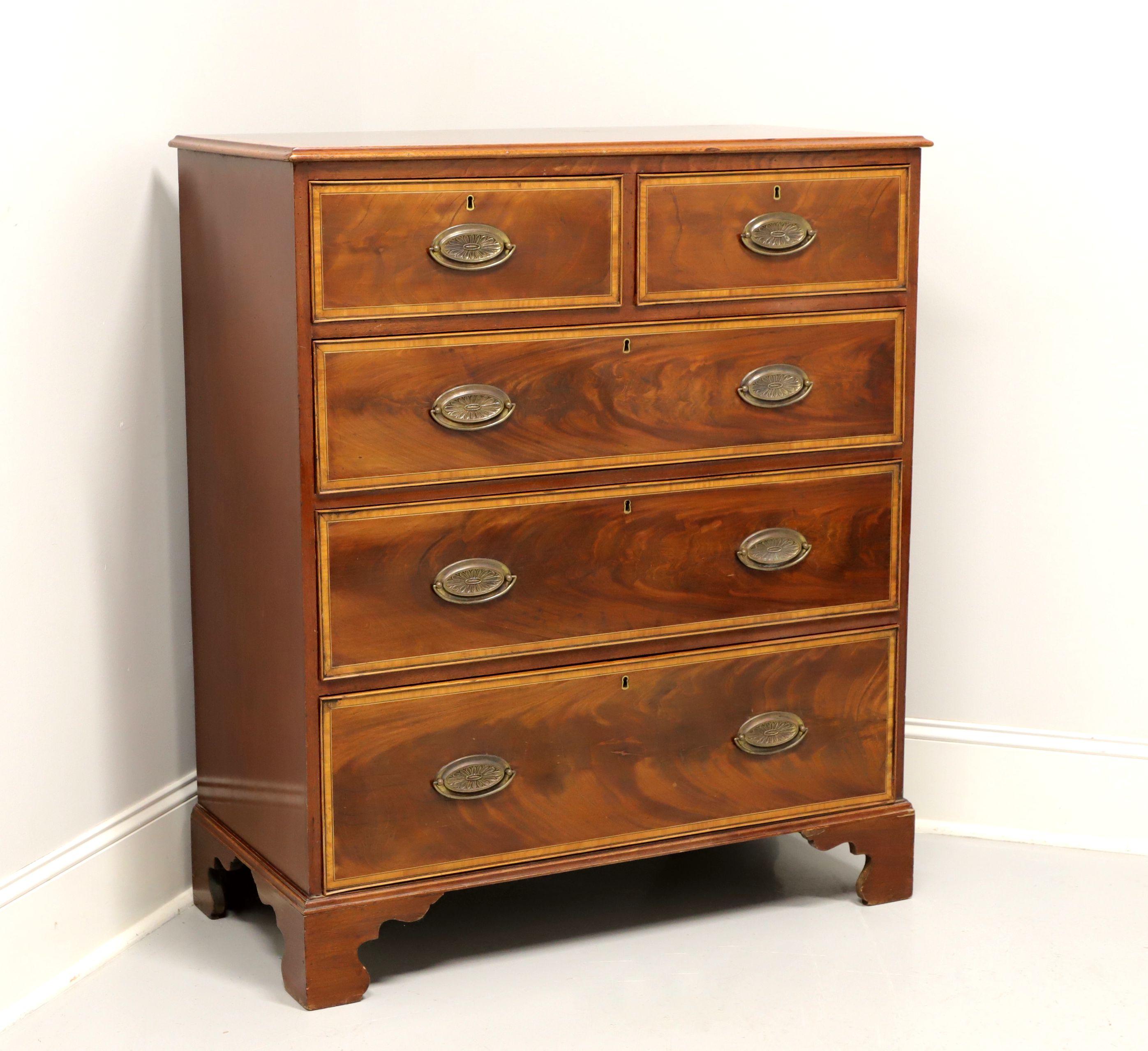 An antique 19th century Georgian style chest of drawers, unbranded. Mahogany with brass hardware, banded top, banded flame mahogany drawer fronts and bracket feet. Features two smaller over three larger drawers of hand dovetailed construction, all