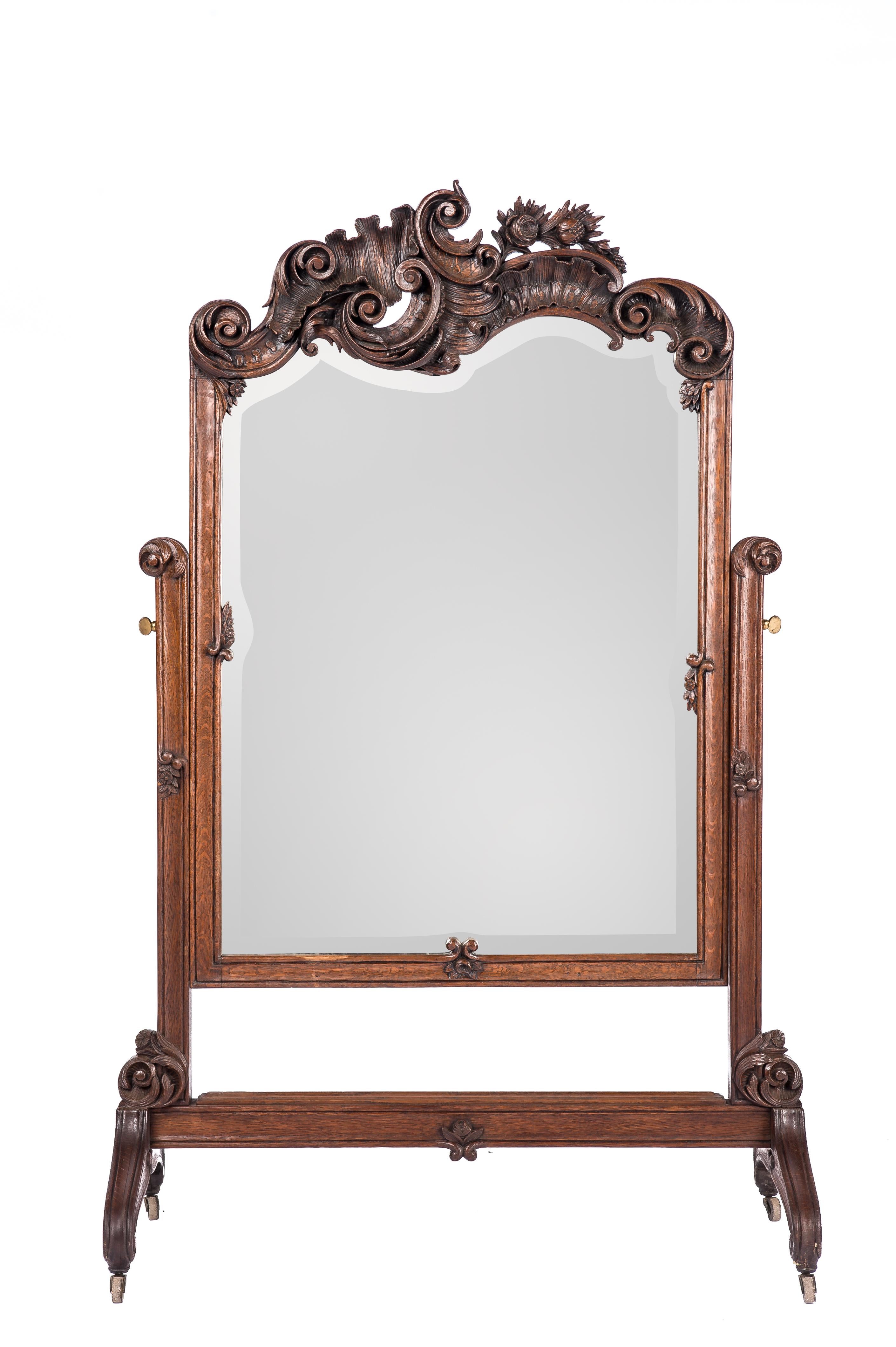 This beautiful hand-carved floor mirror was made in Belgium in the late 1800s. The mirror is a fine example of the highly detailed carved oak ornaments that the Belgian region of Liege is known for. The mirror was carved in the asymmetrical Louis