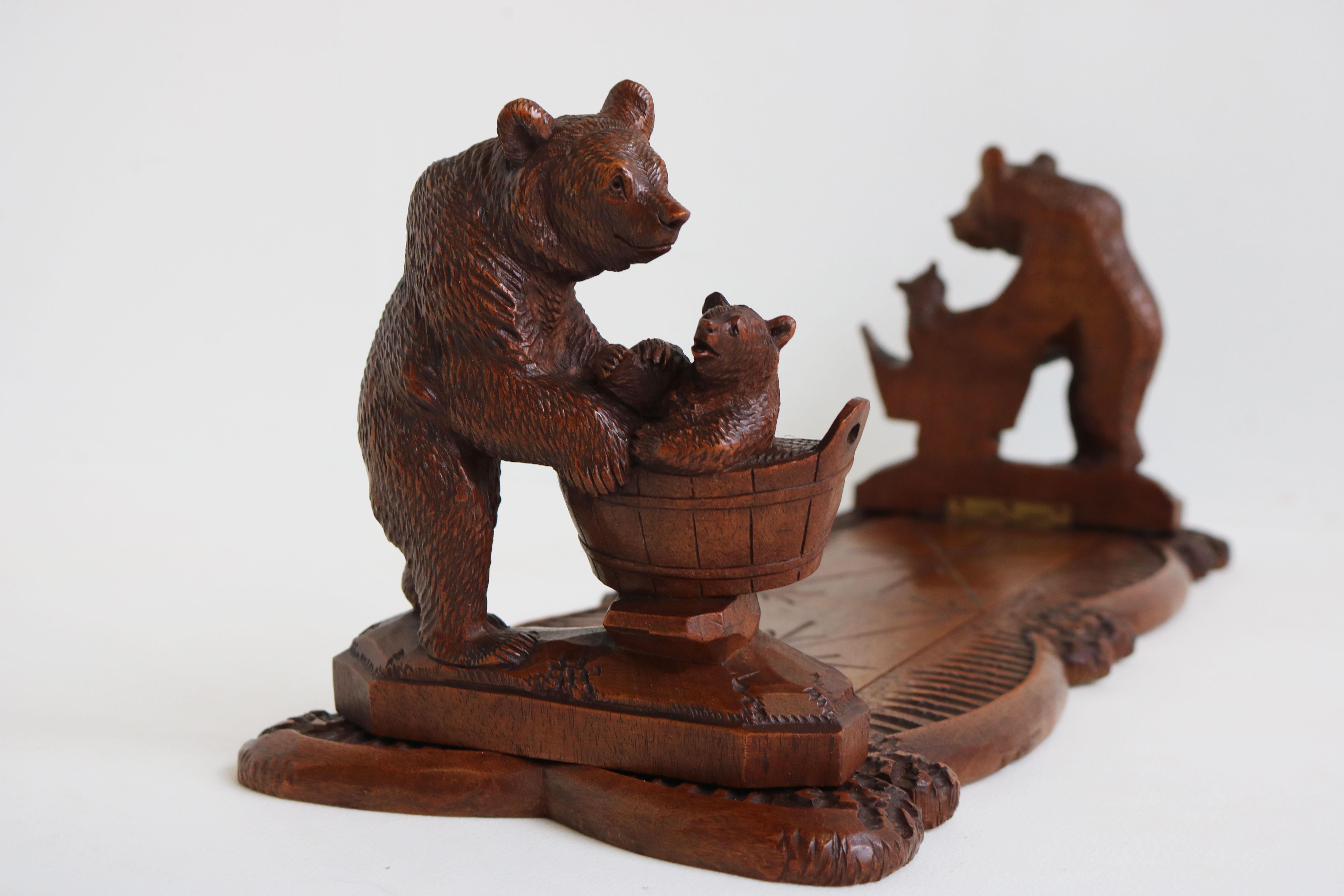 Exquisite & rare! This 19th century black forest books rack/ book shelf with ''Bears holding baby bears'' bookends hand carved Swiss.

Gorgeous 19th century antique Black Forest bookstand with sliding and folding bookends, hand carved from