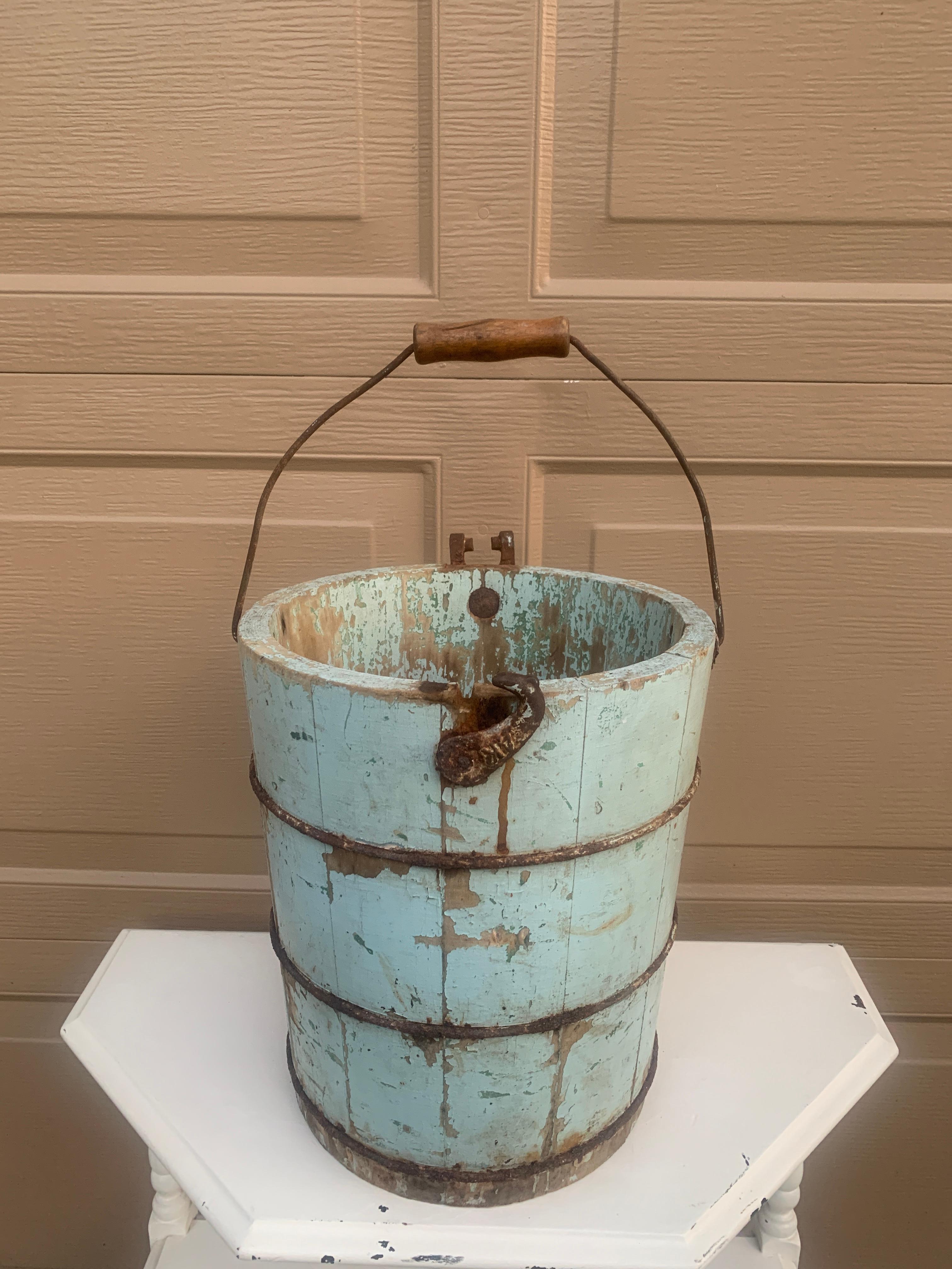 A gorgeous antique 19th century rustic or farmhouse ice cream bucket, painted in a beautiful light blue color, which would make the perfect waste basket

USA, Late 19th Century

Wood, with iron mounts

Measures: 12
