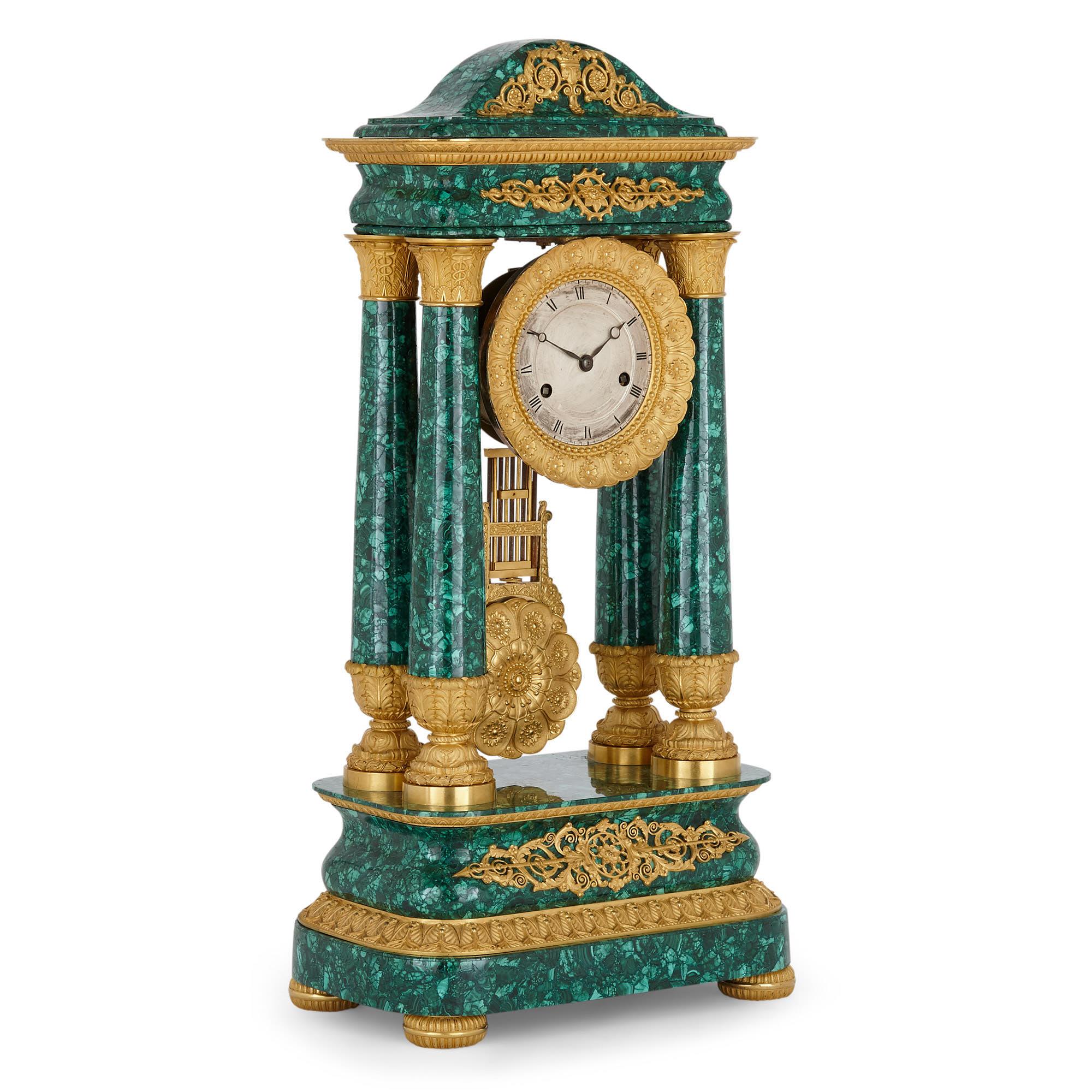 Antique 19th Century Bourbon restauration malachite and gilt bronze mantel clock
French, 1827
Dimensions: Height 65cm, width 32cm, depth 20cm

This beautiful early 19th Century mantel clock was created during the Bourbon Restauration period, and