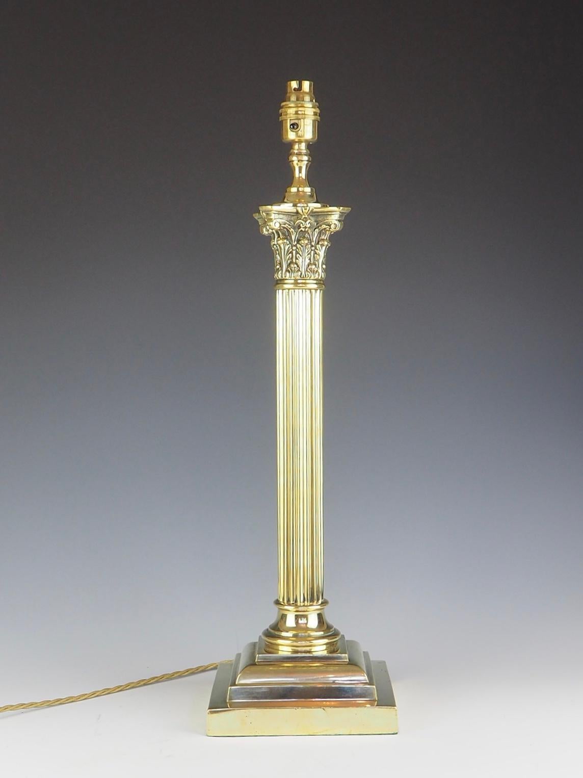 This is a splendid antique Victorian brass columnar Corinthian table lamp, now converted to electricity from oil lamps, late 19th Century in date.

This opulent antique table lamp feature Kingly Corinthian Capital decorated with classical ornate