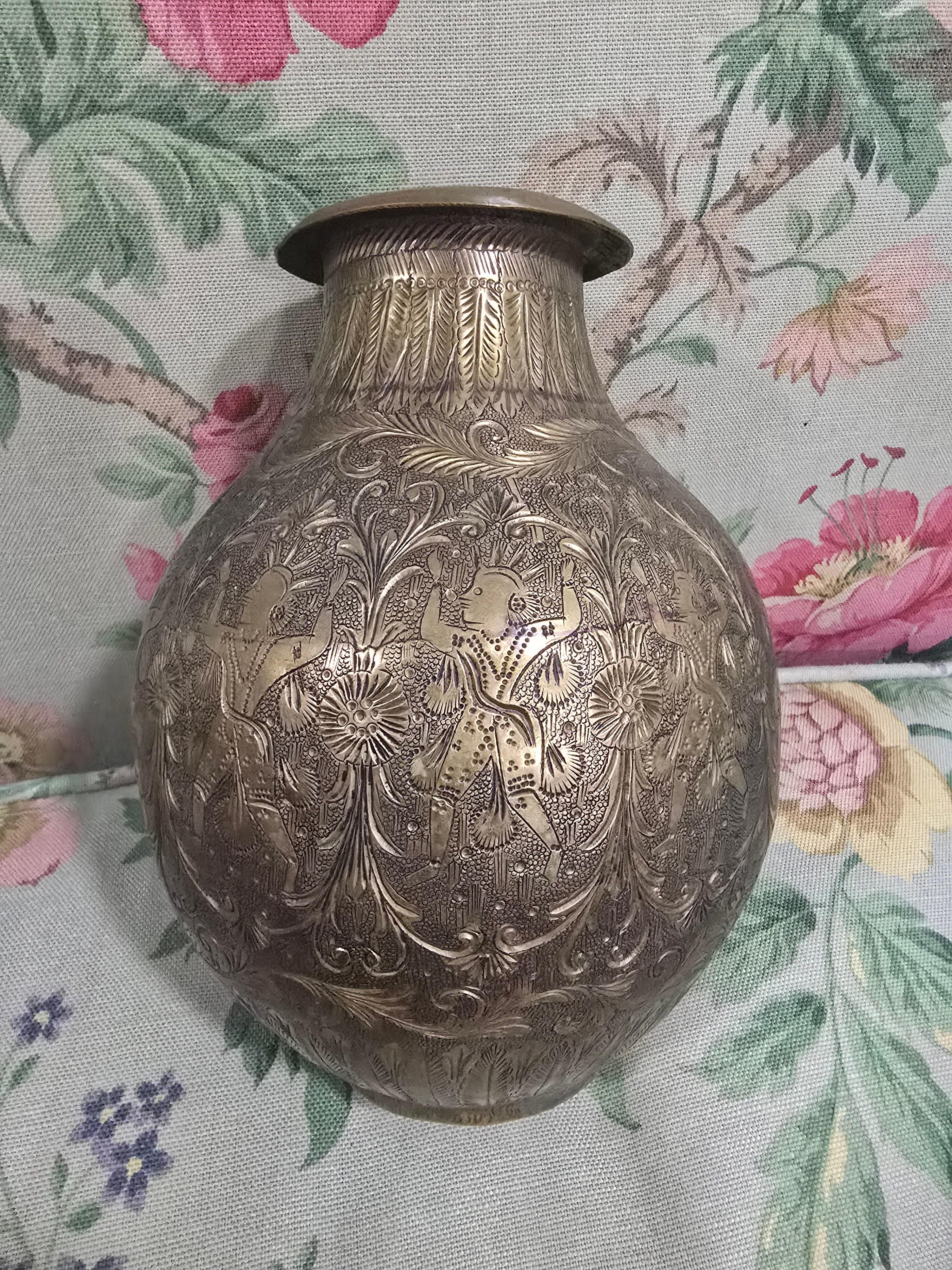 Questo intrigante vaso antico in ottone del XIX secolo presenta squisiti dettagli incisi a mano, con figure esotiche che riflettono la sua unica ispirazione culturale. L'artigianato e il design ornato ne fanno un pezzo decorativo di spicco per i