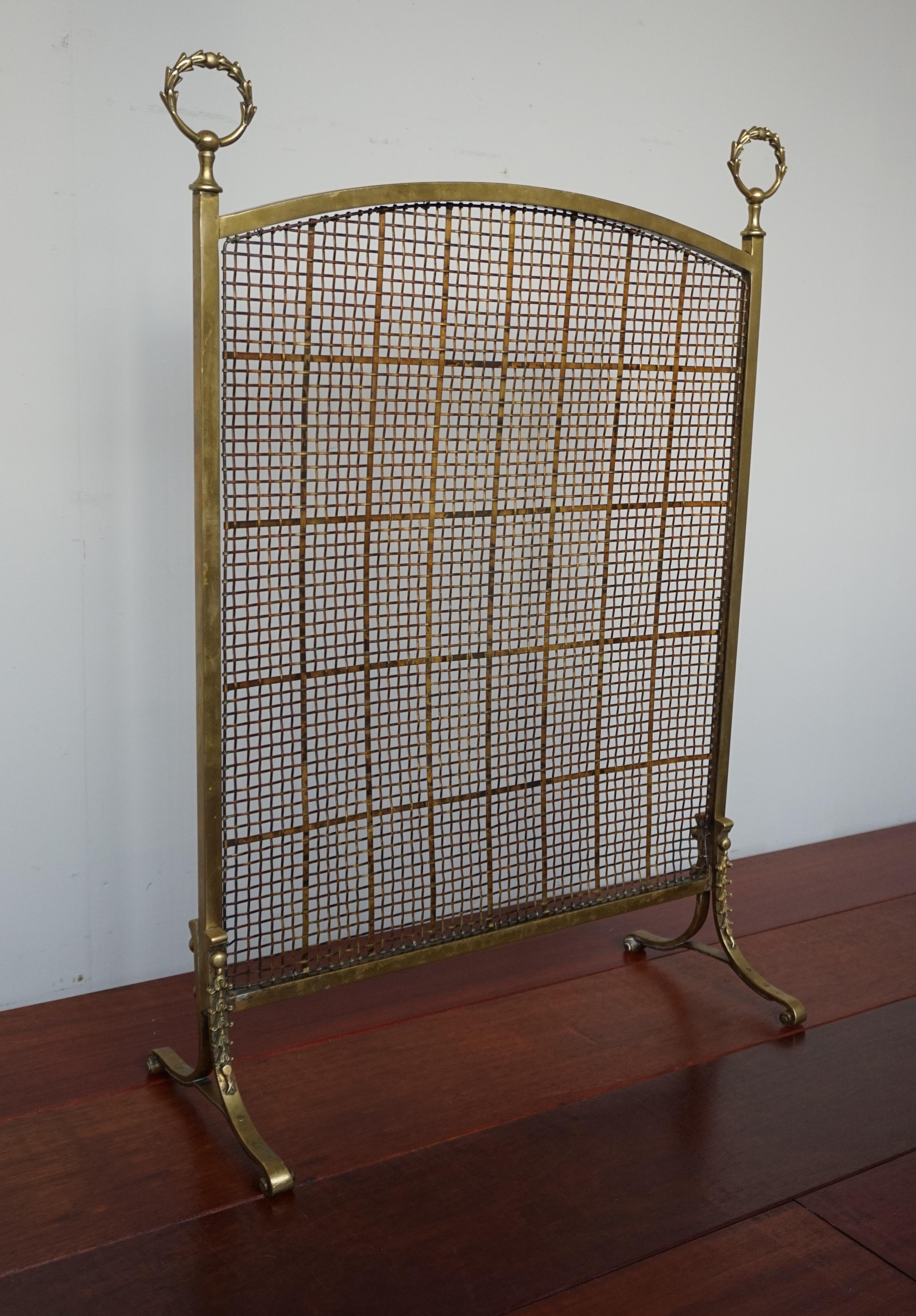 Stylish hand-crafted firescreen from the late 1800s with wreath crown decorations.

If this beautifully hand-crafted 19th century firescreen is the right style to fit your fireplace and the size is correct for your needs then you could hardly wish