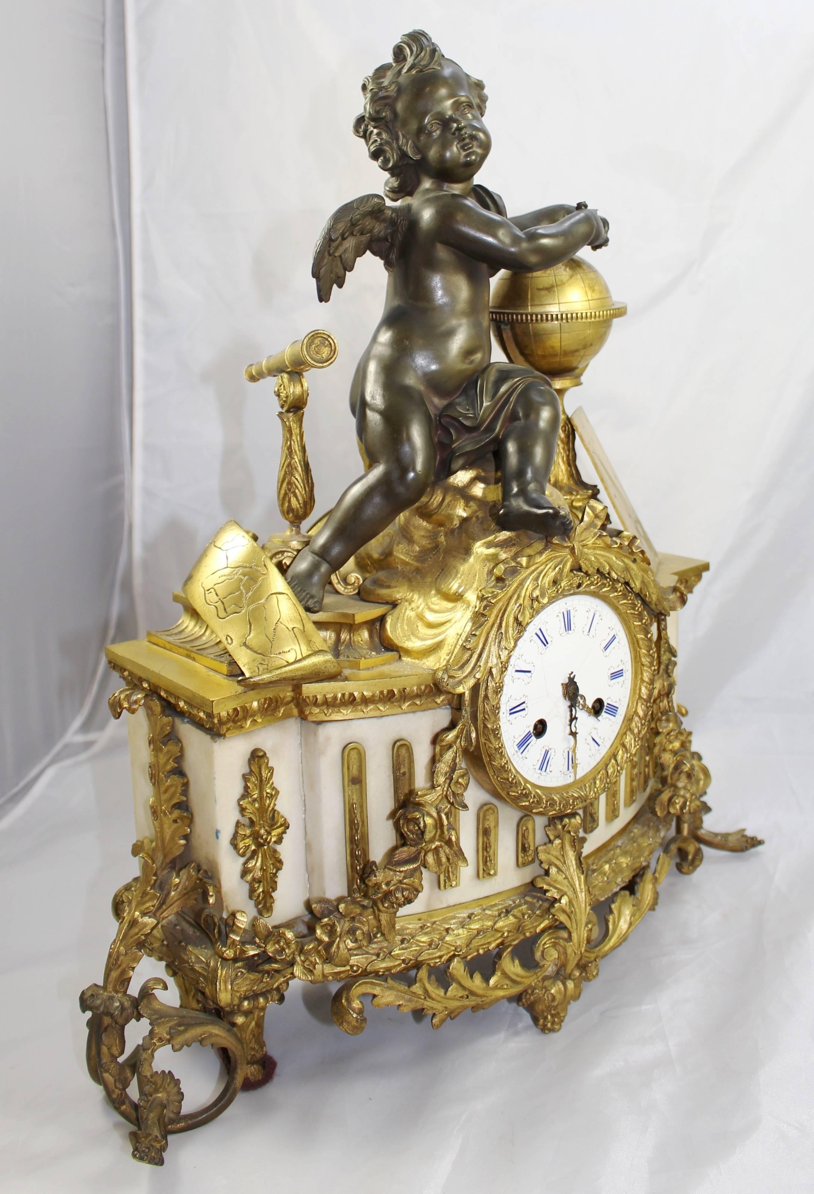 Period 
19th century.

Dial 
enamel dial with Roman numerals, brass hands, two winding holes, brassouter ring

Decoration 
marble body with bronze putti atop, brass globe and telescope. Heavy ornate ormolu mounts to the body, ormolu