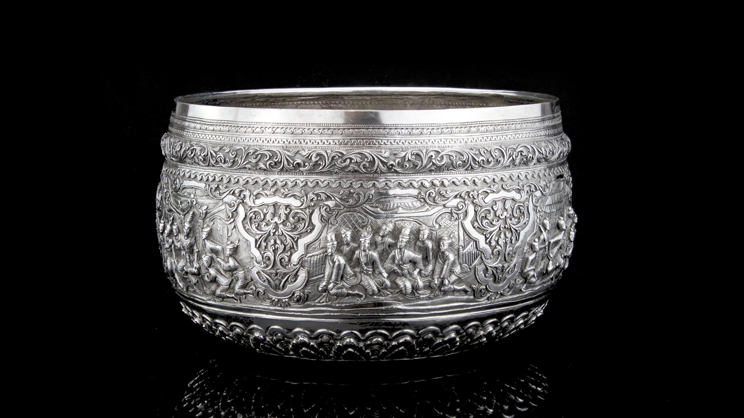 Antique 19th century Burmese silver thabeik bowl repousseé decorated in high relief depicting scenes from the traditional culture which includes, hunting scenes, battle / war scenes, teaching scenes, praying and dancing. The figures in this bowl are