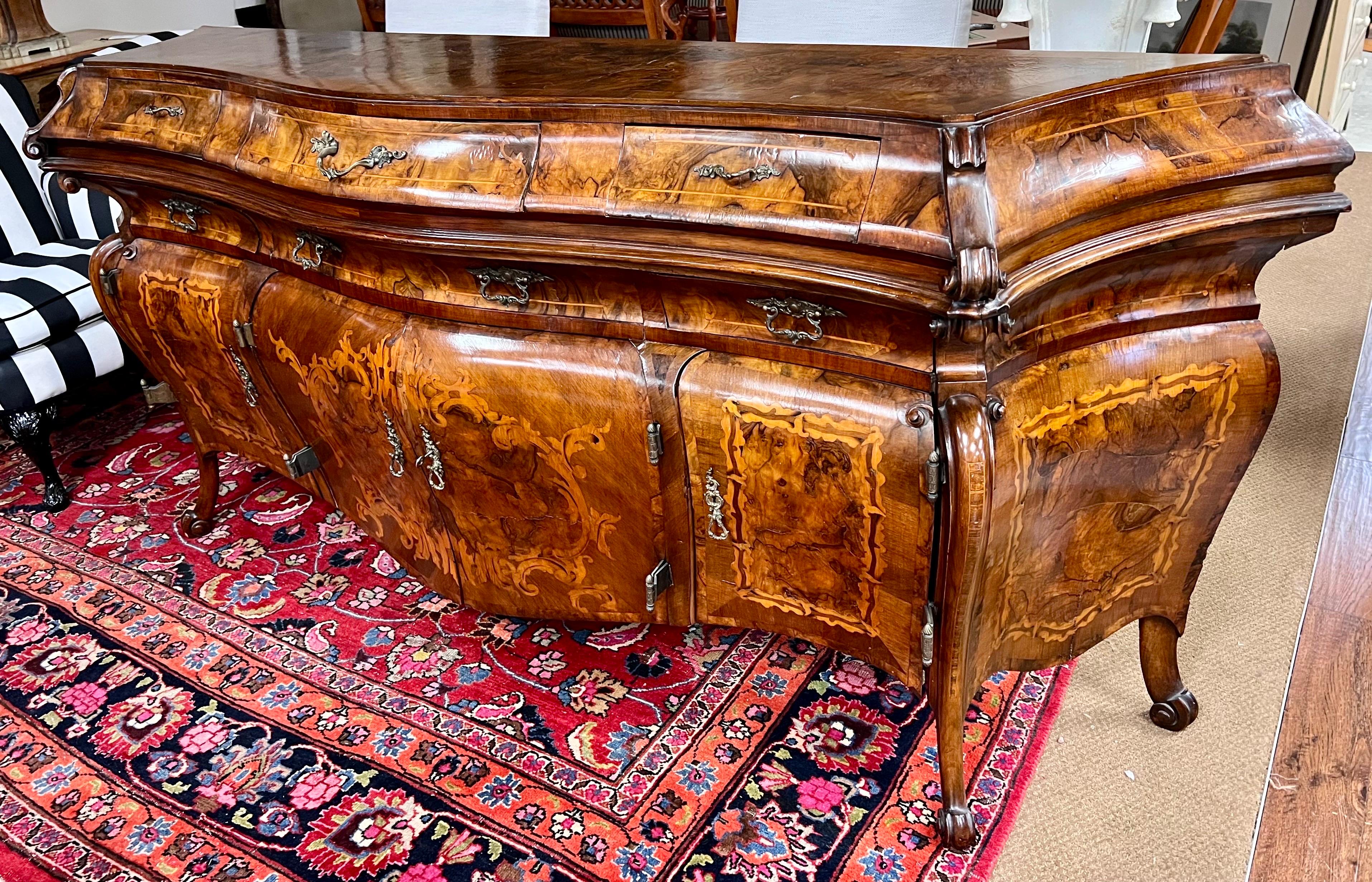 Discover opulence in every detail with this magnificent 19th century burr walnut marquetry French Bombe style credenza/sideboard.  Immerse yourself in the timeless allure of burr walnut, adorned with exquisite marquetry craftsmanship from the last