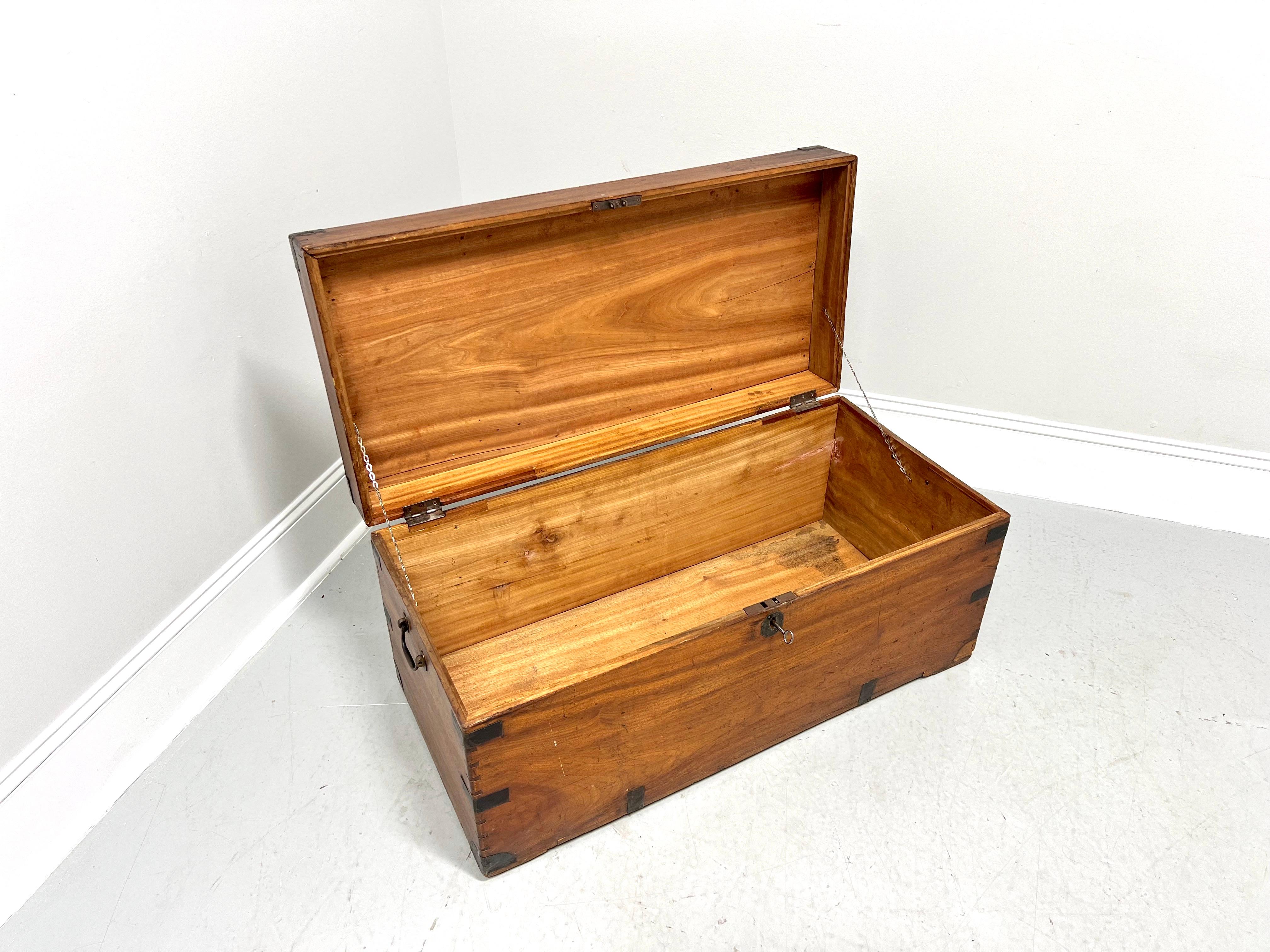 A 19th Century Campaign style sea captain's military trunk, unbranded. Solid camphorwood, brass accents to protect corners & sides, brass side handles, distinctive side joinery, working lock with key (disassembled as required by law), a hinged lid