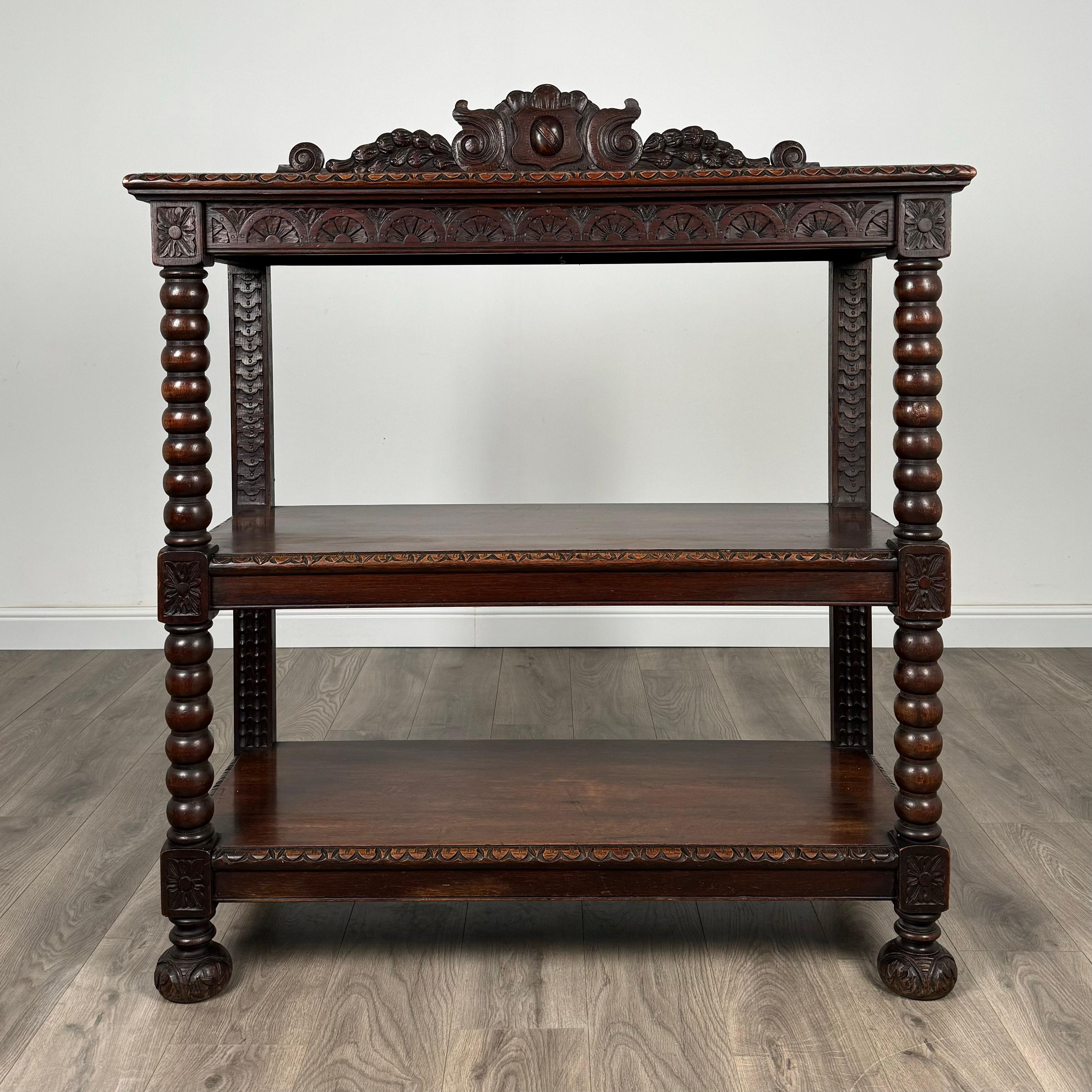 Immerse yourself in the elegance of the past with this stunning 19th century oak buffet/sideboard, crafted circa 1870, boasting intricate carvings and superior craftsmanship. This remarkable piece of furniture is a true statement of opulence,