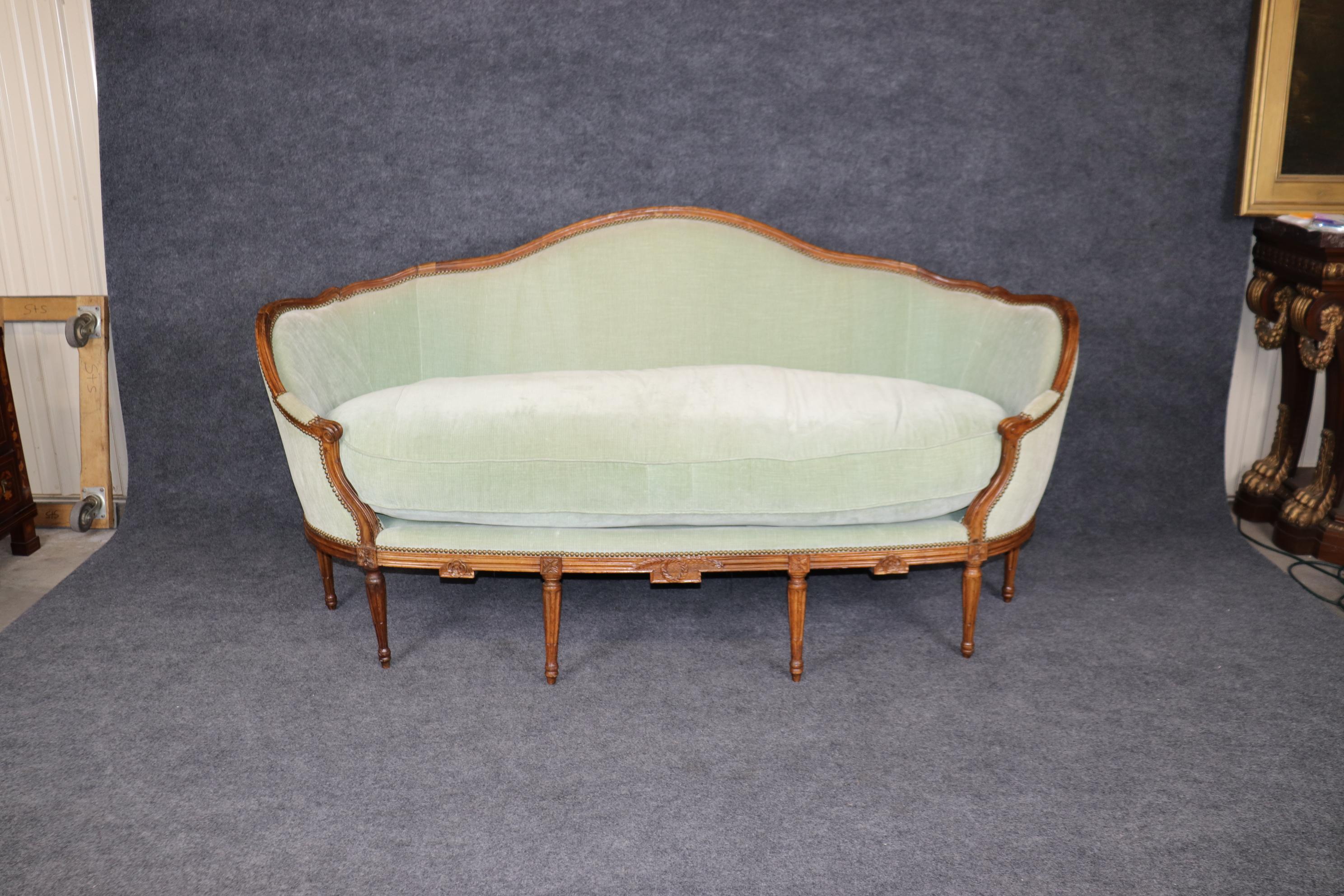 This is a spectacular French made antique 1890s sofa in the corbielle style. The sofa has a tall goose down feather down cushion and is in good condition and very, very comfortable. The sofa has all of its original signs of age and use such as minor