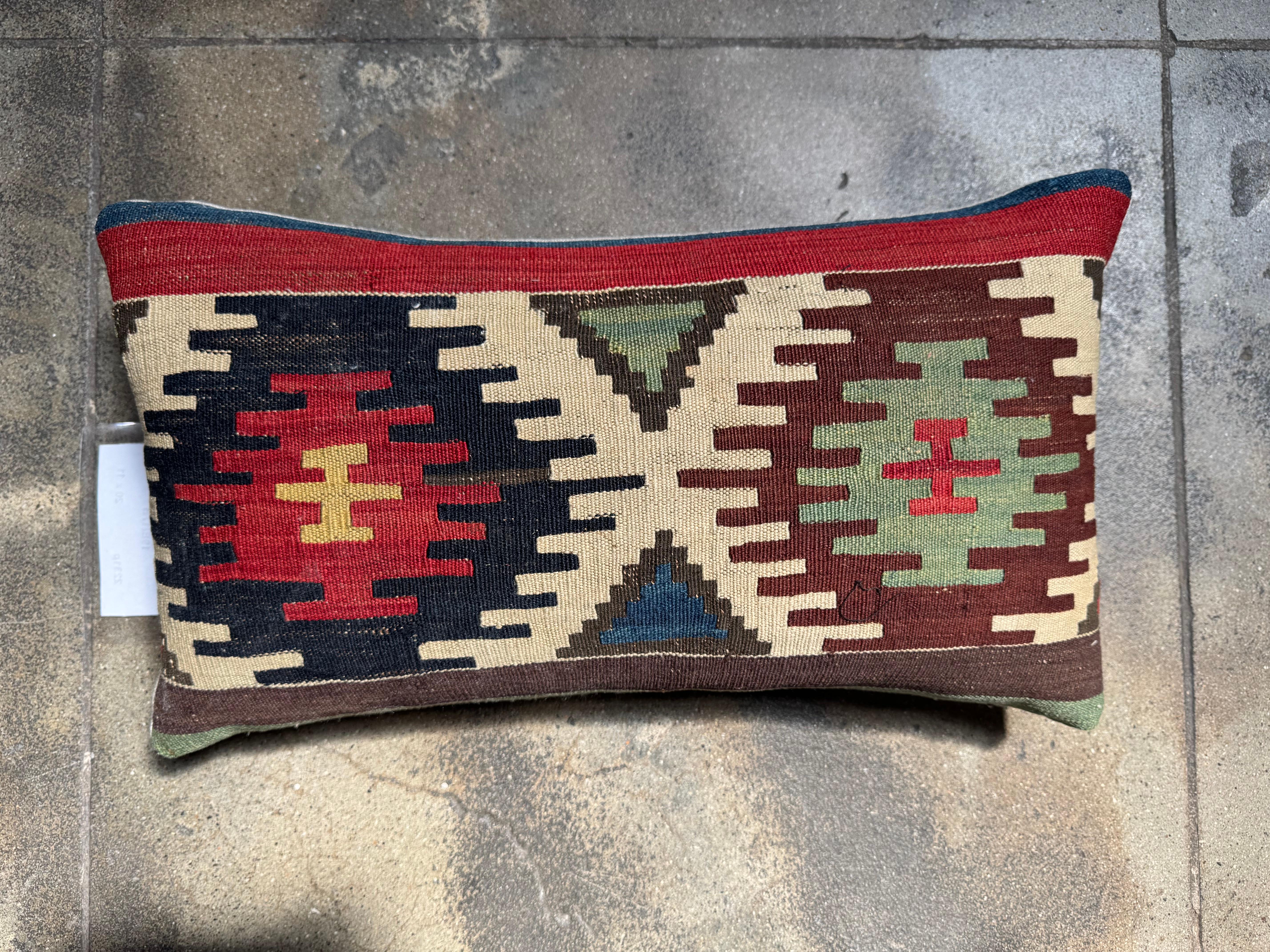 Vibrant, geometric, and full of cultural richness, this 19th century Caucasian kilim lumbar pillow is a striking accent that blends time-honored design with contemporary styling. Woven from antique tribal wool, it features traditional medallion