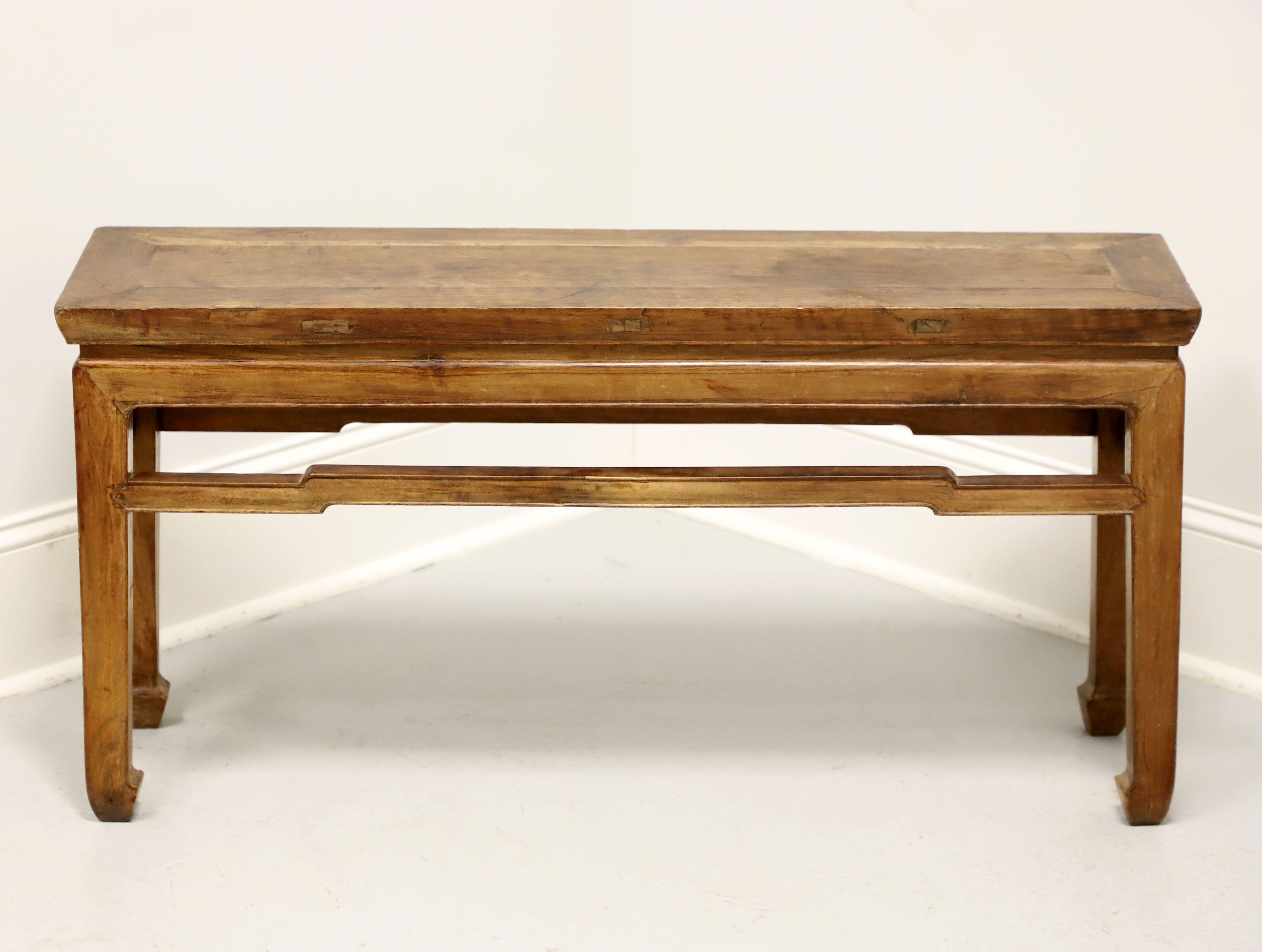 An antique Asian Ming style bench, unbranded. Solid Chinese elm, banded seat, carved stretchers, slightly tapered square legs, and turned inward spade feet. Likely made in Asia, in the late 19th Century.

Measures:  Overall: 41.25w 11.75d 20.25h,