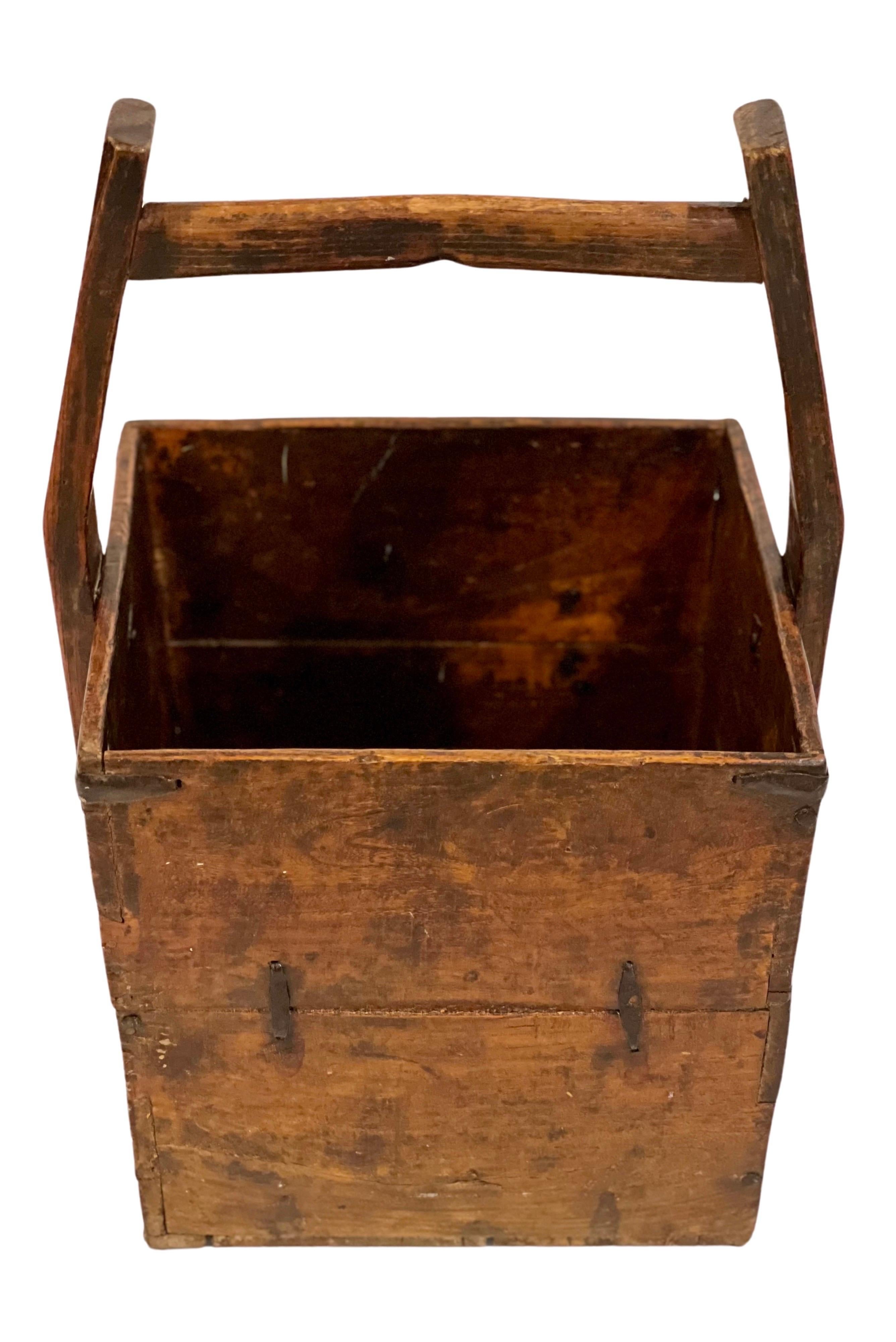 Antique Chinese rice harvest bucket, c. late 19th century.

Handcrafted, very sturdy elm bucket with original, hand-forged iron hardware reinforcements and dovetail construction. Also called a 