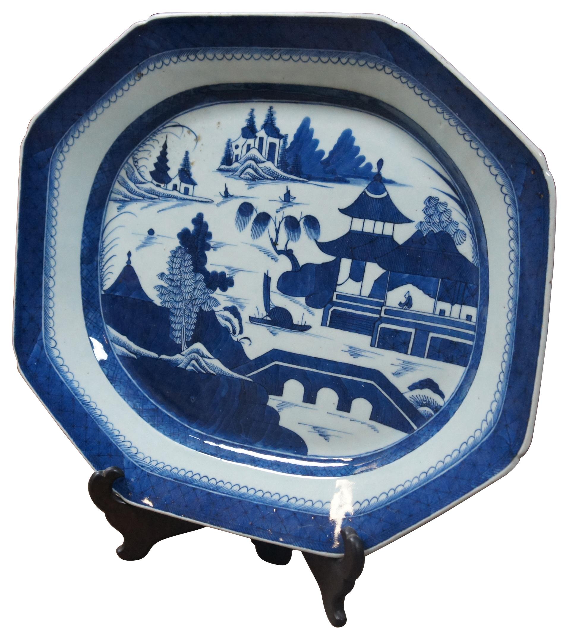 Large 19th century Canton Chinese export platter in blue and white painted porcelain; includes folding wood display Stand. “Canton and Nanking are both patterns of dishes made in China from the late 1700s to the early 1900s. Both are named for