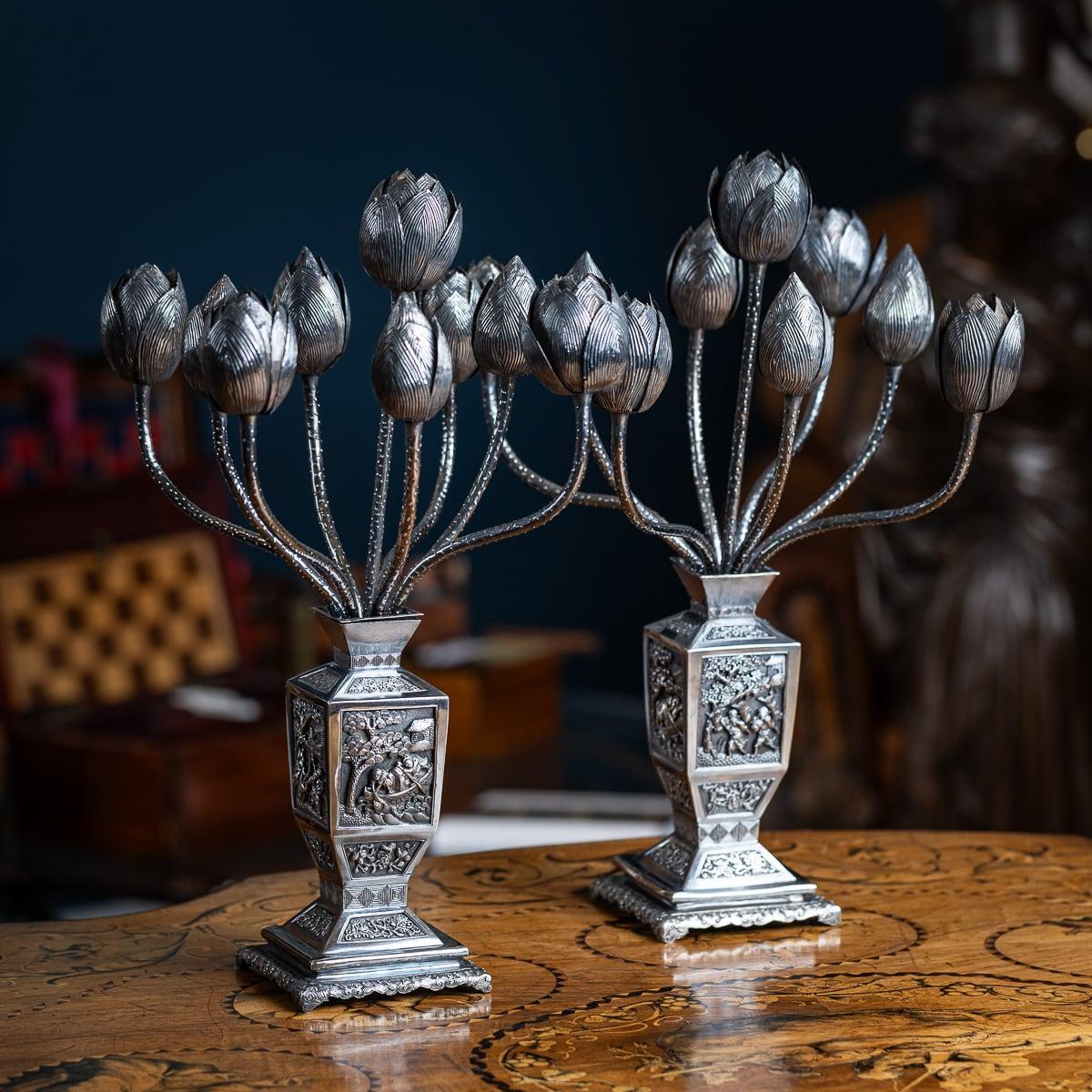 Antique 19th Century Chinese export solid silver exremely rare and unusual pair of candelabras. Modelled as a pair of matching vases with quadrangular sides, embossed and deeply chased decoration, panels depicting villagers, floral compositions and
