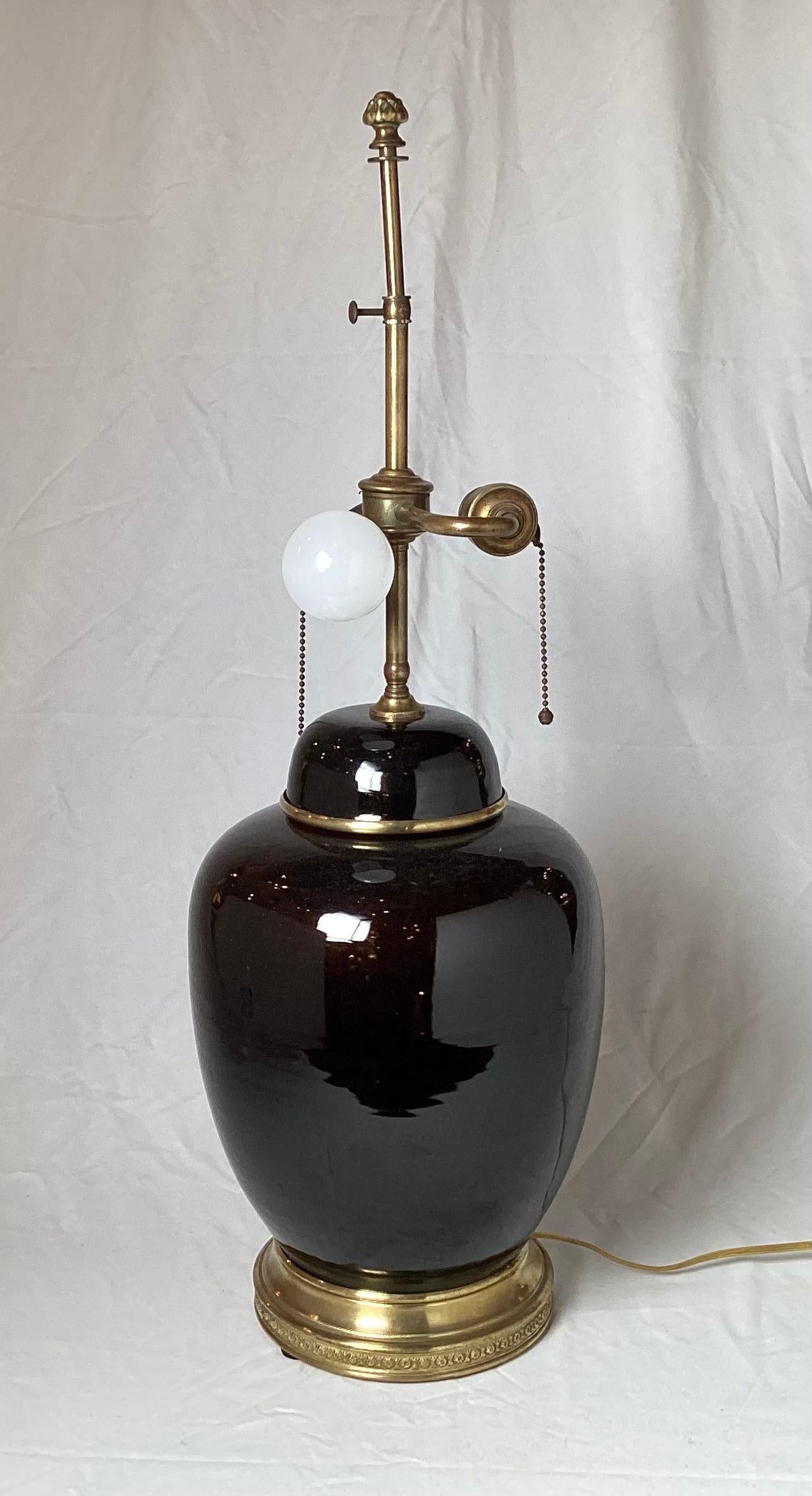 A stunning antique Chinese porcelain 19th century jar, as a lamp. The porcelain jar is in a Mirror black glaze, which is a very dark The Lamp measures 27 inches to the top of the shade, the porcelain jar measures 9.5 inches in diameter, and 8 inches