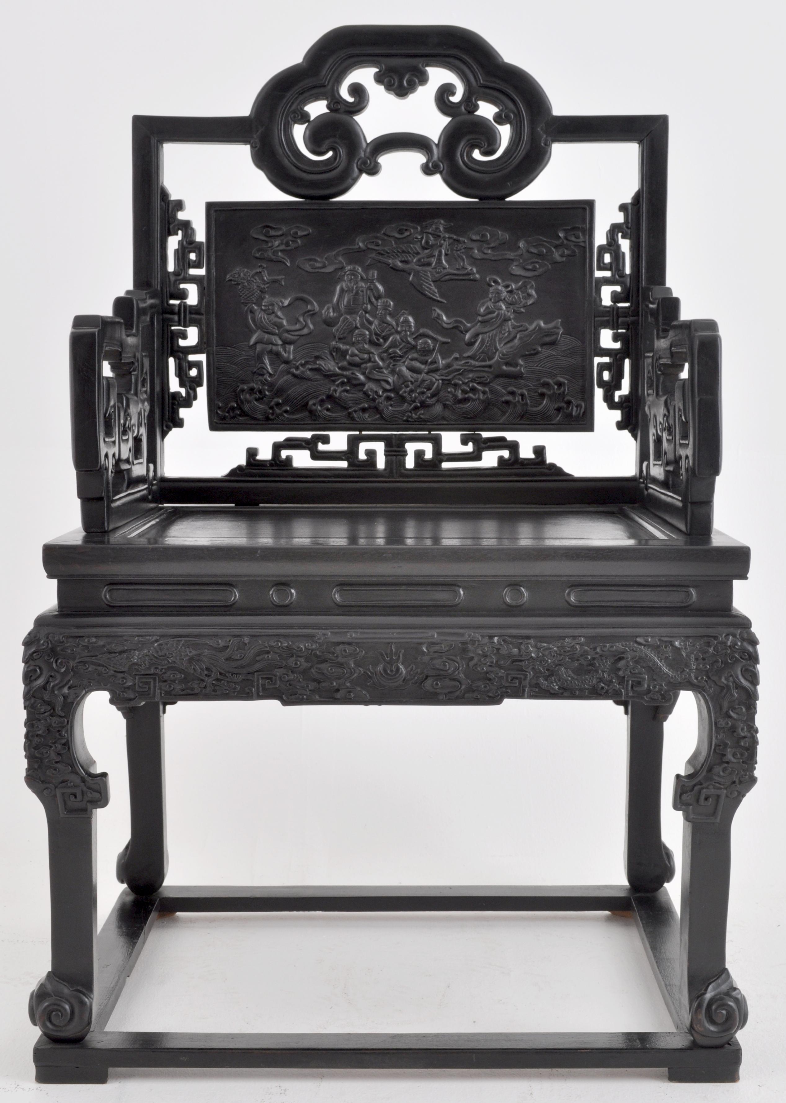 Antique 19th century Chinese Qing Dynasty carved ebonized rosewood chair, circa 1890. The chair having a tablet-shaped backsplat decorated with Chinese immortals in a cloudscape surrounded by mythical beasts. The arms having reticulated and scrolled
