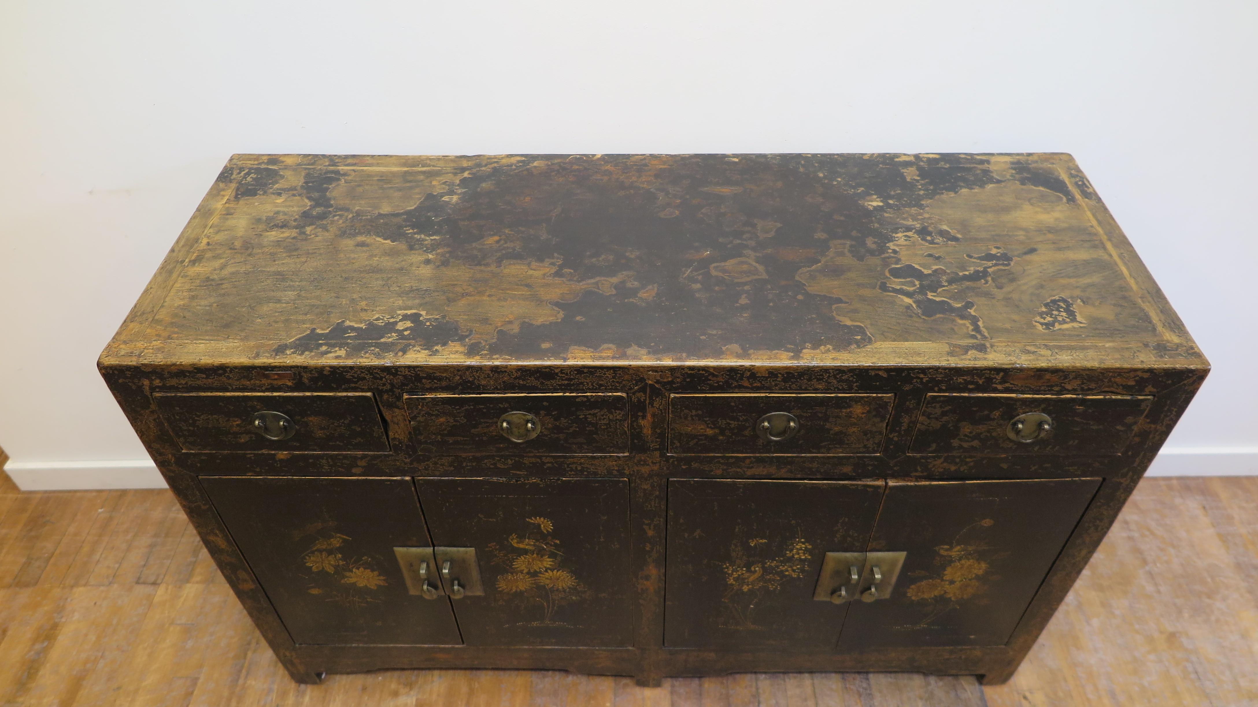 Antique Chinese sideboard 19th century from Shanxi China. Worn black lacquer sideboard with painting having a spectacular time endured patina. Paint work depicting seasonal flowers and birds. Very good condition with significant patina and original