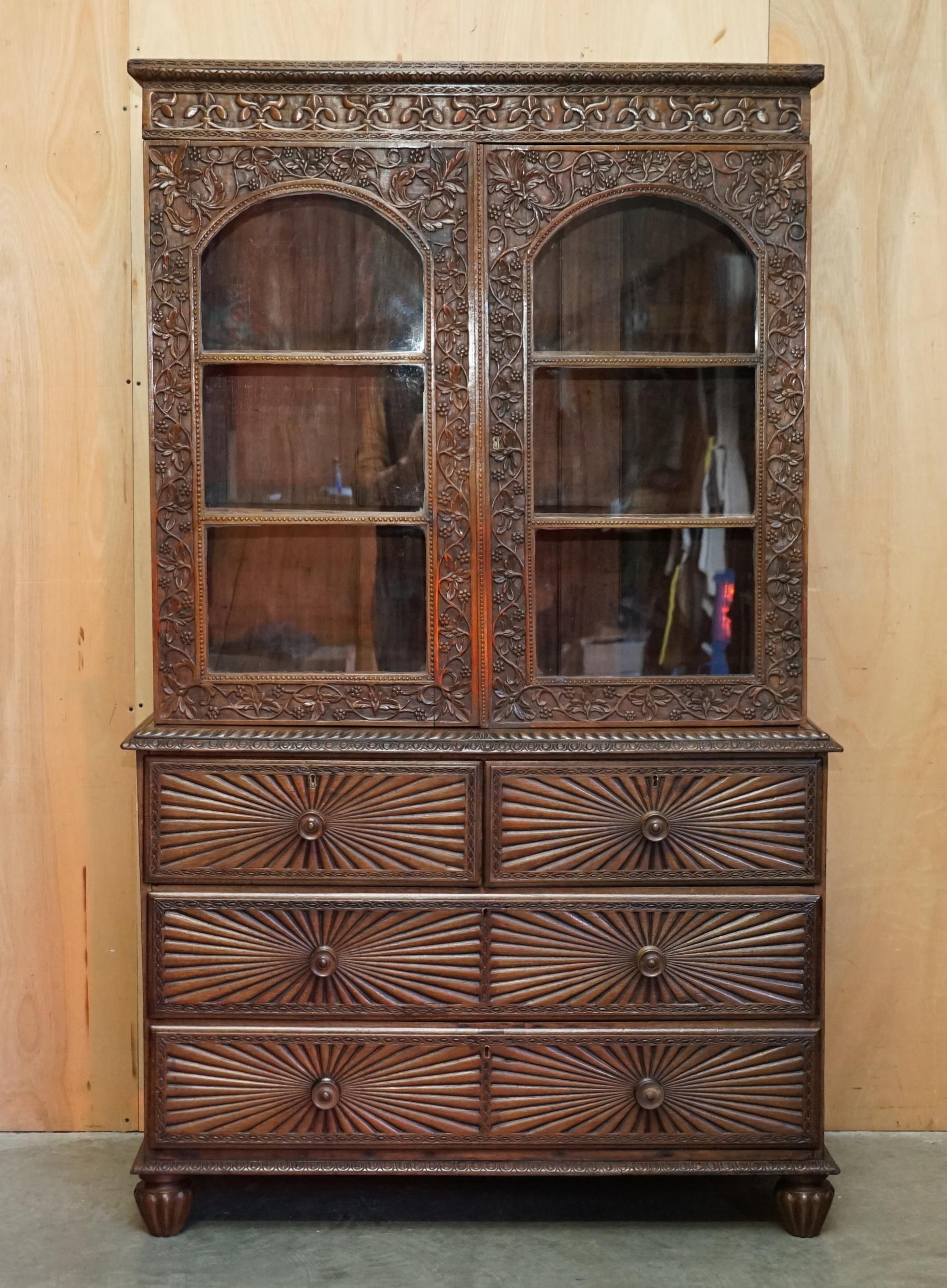 Royal House Antiques

Royal House Antiques is delighted to offer for sale this original antique Anglo Indian Colonial Rosewood hand carved bookcase on chest of drawers Circa 1880

Please note the delivery fee listed is just a guide, it covers within