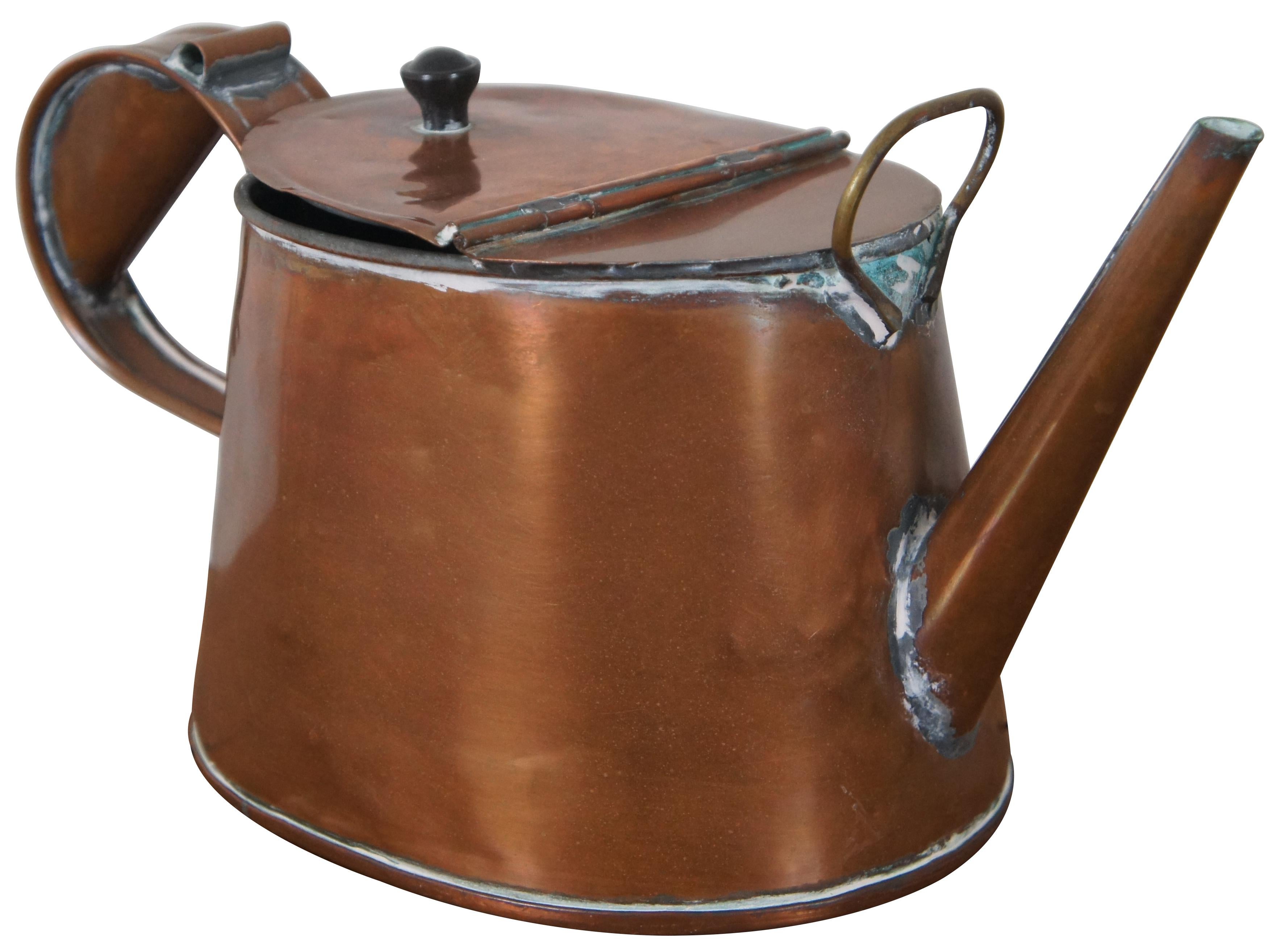 Antique 19th century copper tea kettle with oval body, straight spout, large flip top opening, hefty handle and brass ring at the front. Measure:14