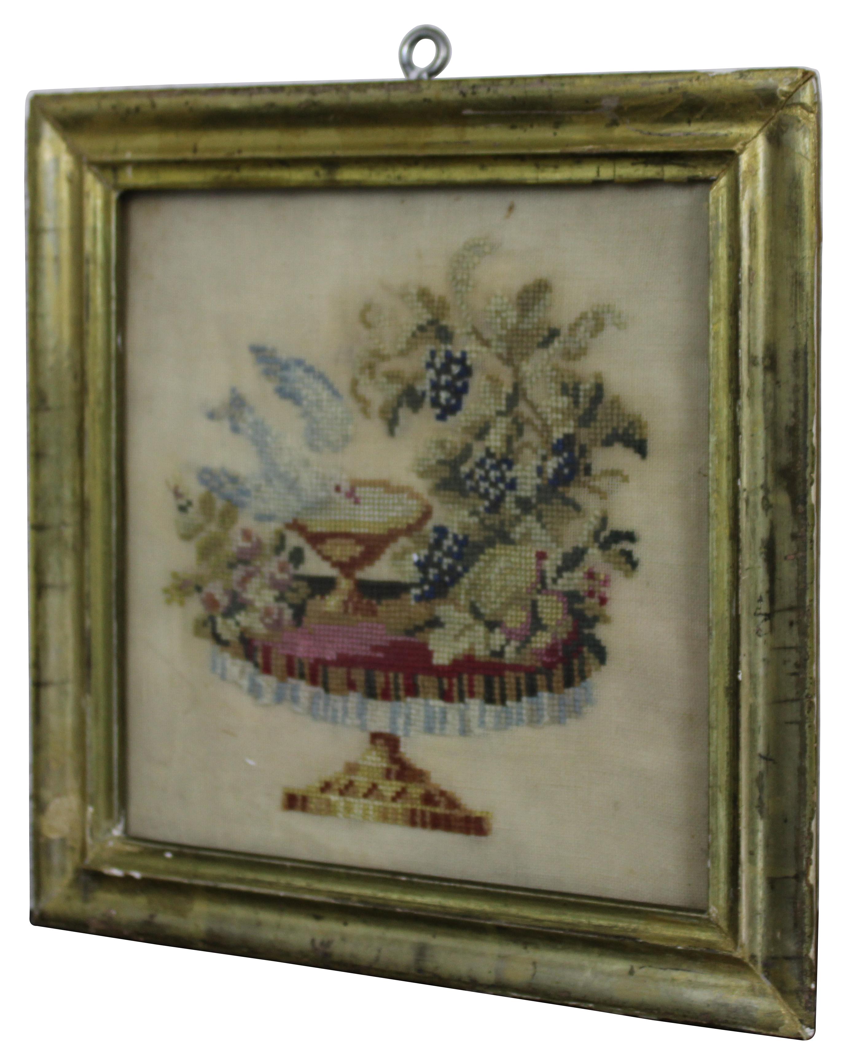 Antique mid 19th century folk art embroidery sampler showing a small pedestal table set with flowers, grapes, and a dove drinking or bathing in a bird bath.

Measures: 9” x 1” x 9” / Sans frame - 7” x 7” (width x depth x height).
     