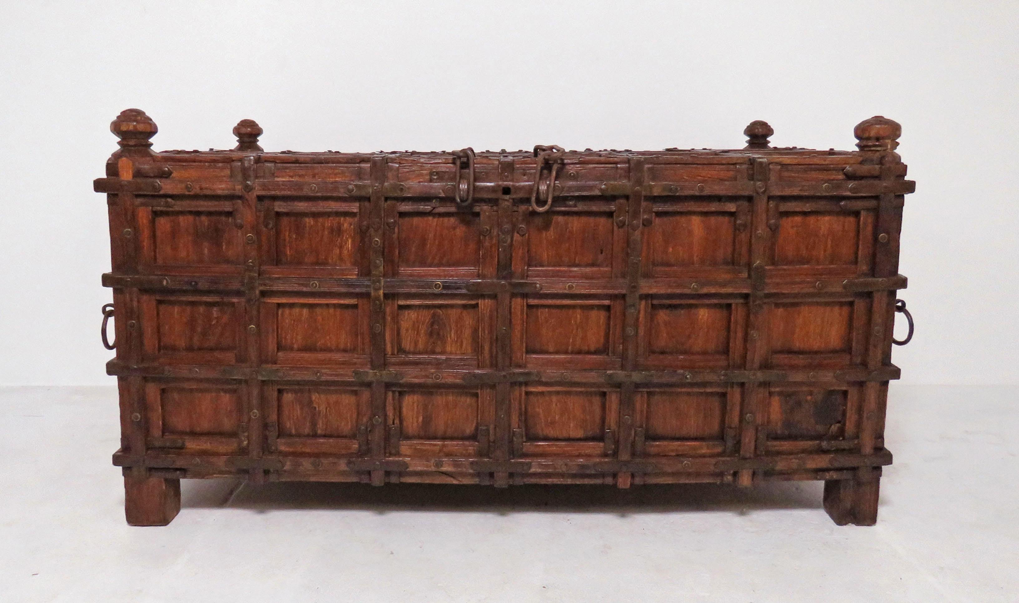 Monumental antique Anglo-Indian Damchiya, or dowry chest. Carved Burmese teak with hand forged iron strap work. Used for collecting and storing a young bride’s most precious silks, strongboxes such as this trace their origins to those created for