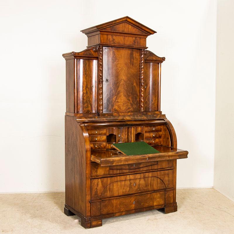 This stunning Biedermeier secretary was crafted in Denmark during a peak era known for high quality furniture craftsmanship. Enlarge photos to appreciate the beauty of the wood, note the curve of each door and how the carved elements and turned