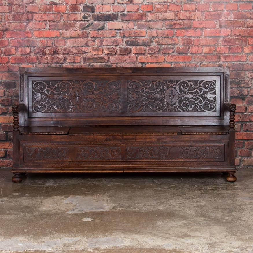 It is the highly decorative hand carving along with the deep, rich patina of the aged walnut that create such a strong visual appeal in this wonderful bench from the late 1800s. Enlarge the photos to appreciate the incredible scroll work, along with