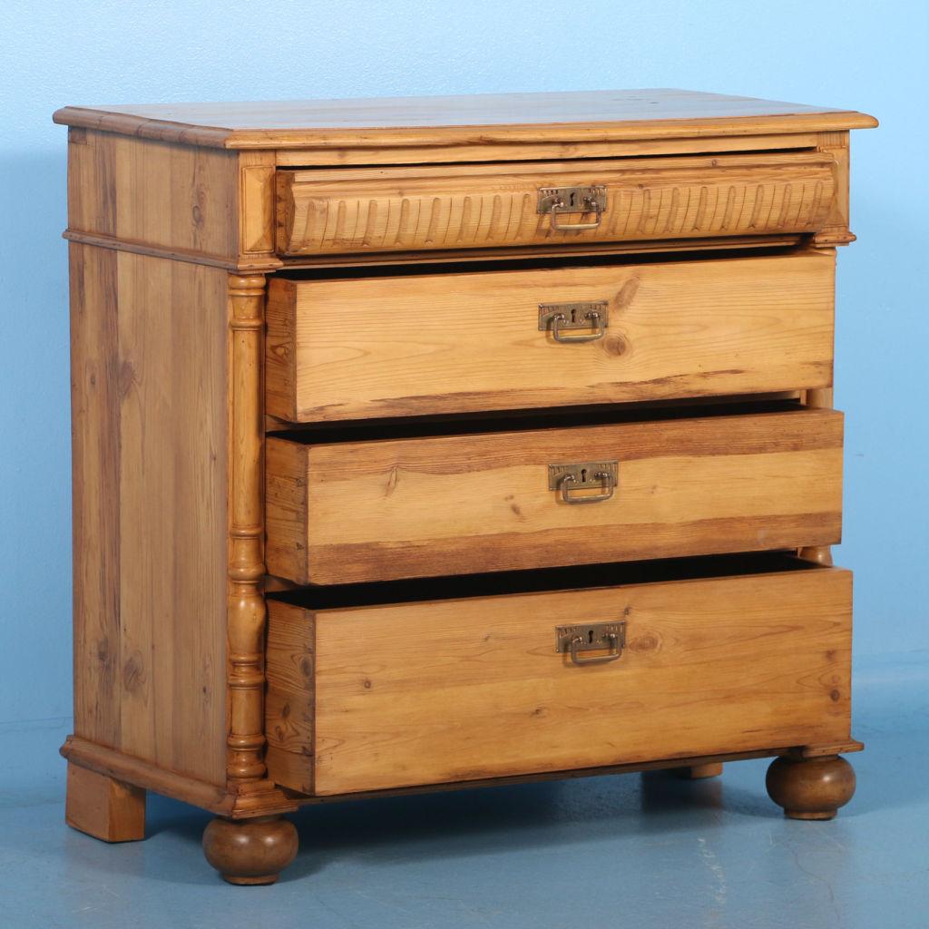 This lovely pine chest of drawers from Denmark circa 1860-1880, has been given a wax finish to bring out the warmth of the wood. The dentil molding along the top drawer and decorative half columns along the sides were often used as style elements in