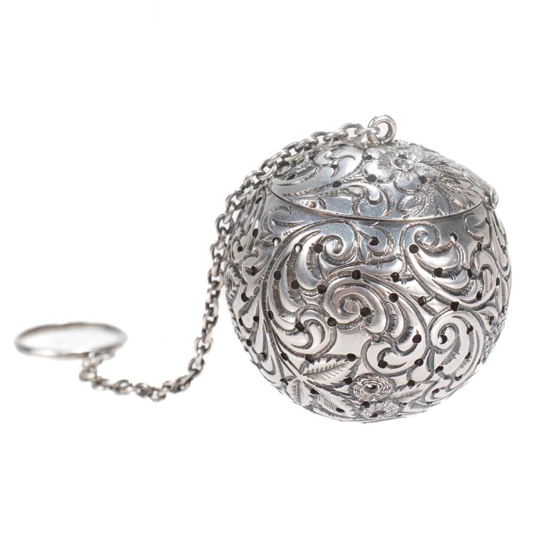 A fine antique, American large-sized tea ball or infuser.

In sterling silver.

By David & Gault, silversmiths active in Philadelphia in the 1880's and 1890's.

The thick gauge sterling tea ball has floral repousse decoration throughout, an integral
