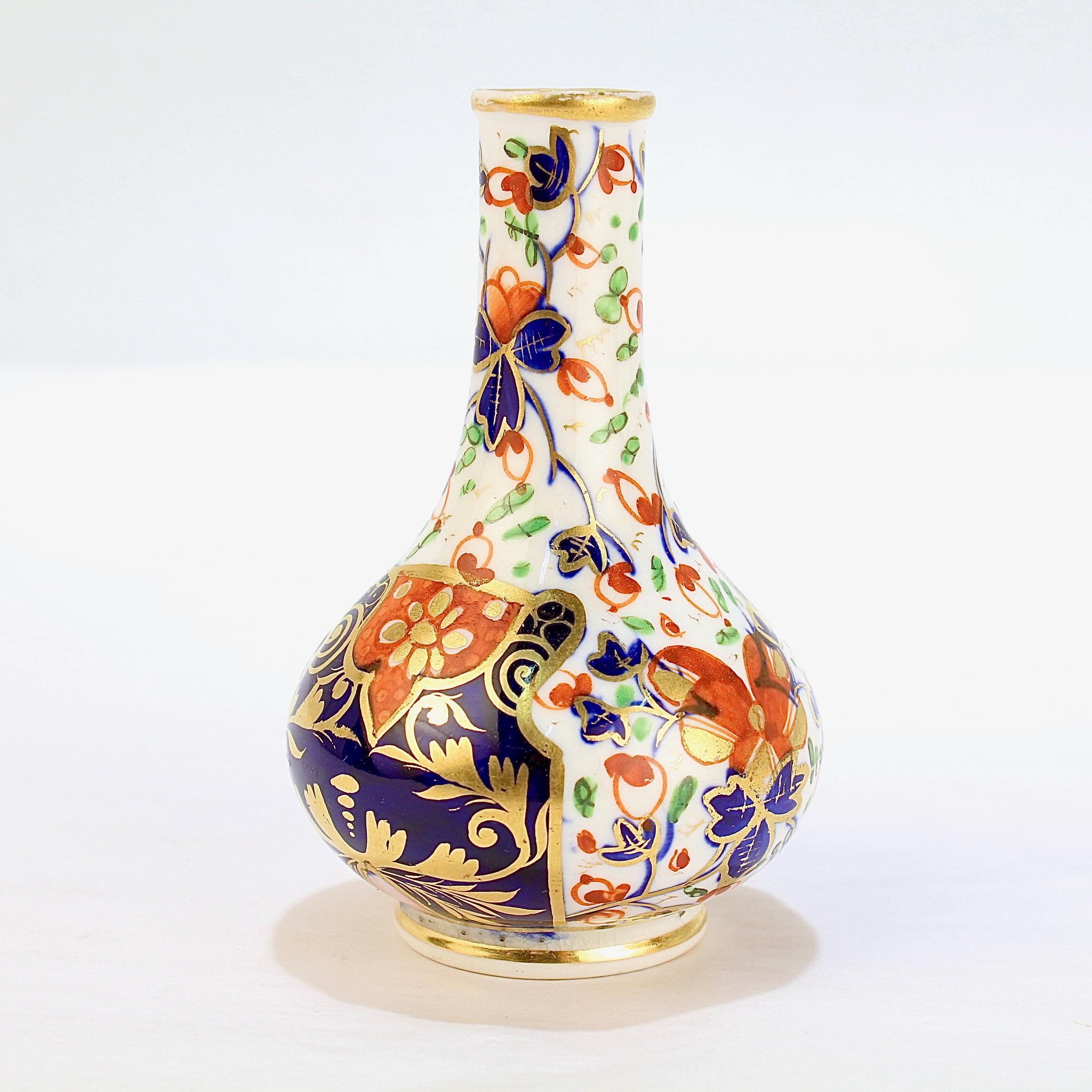 A fine antique English porcelain bud vase

By the Derby Porcelain Manufactory (later known as Royal Crown Derby).

Decorated in an Imari pattern with cobalt blue, reds, green, and richly gilded. 

Simply a wonderful example of Derby