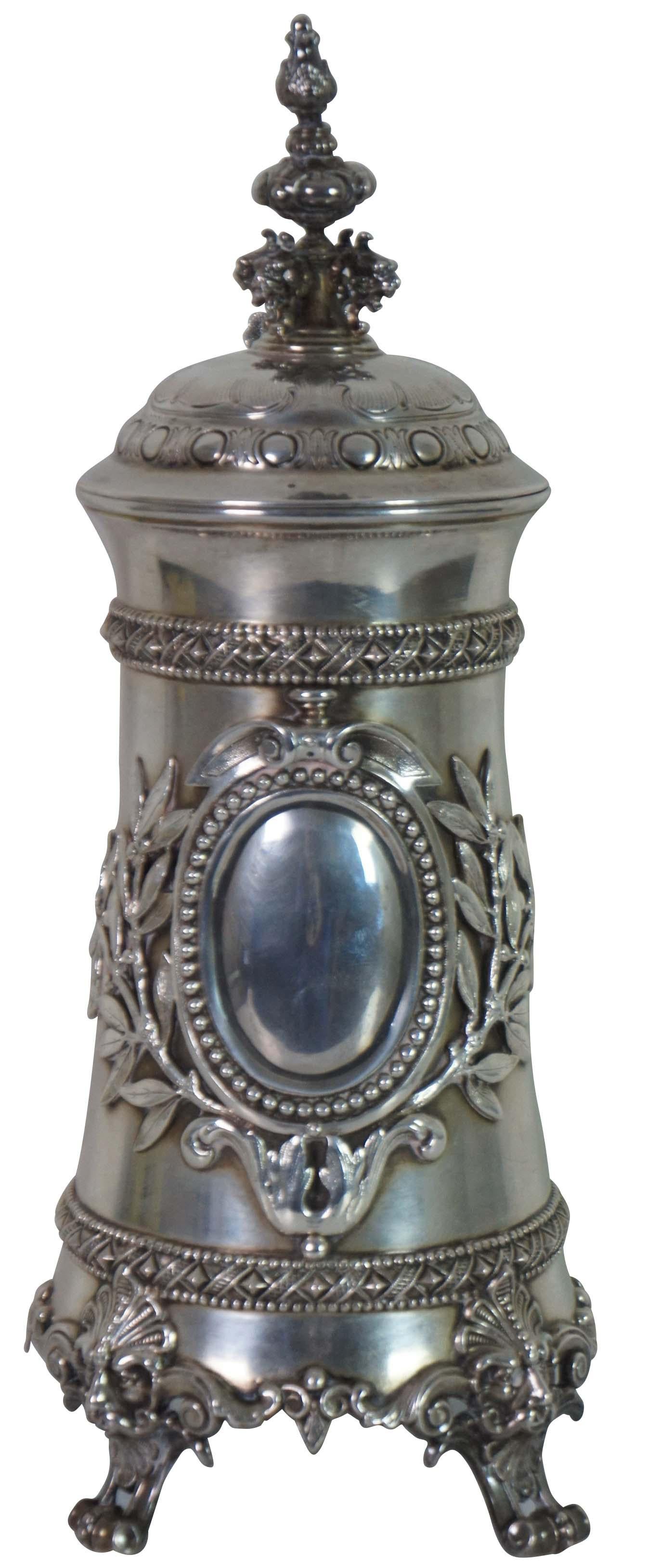 Rare antique 19th century Dutch lidded and footed 800 silver tankard/stein / pitcher, with ornate designs, faces and finial; gilded interior. Marked on base “JW 800M.”

Provenance: Jerome Schottenstein Estate, Columbus Ohio. Jerome was was an
