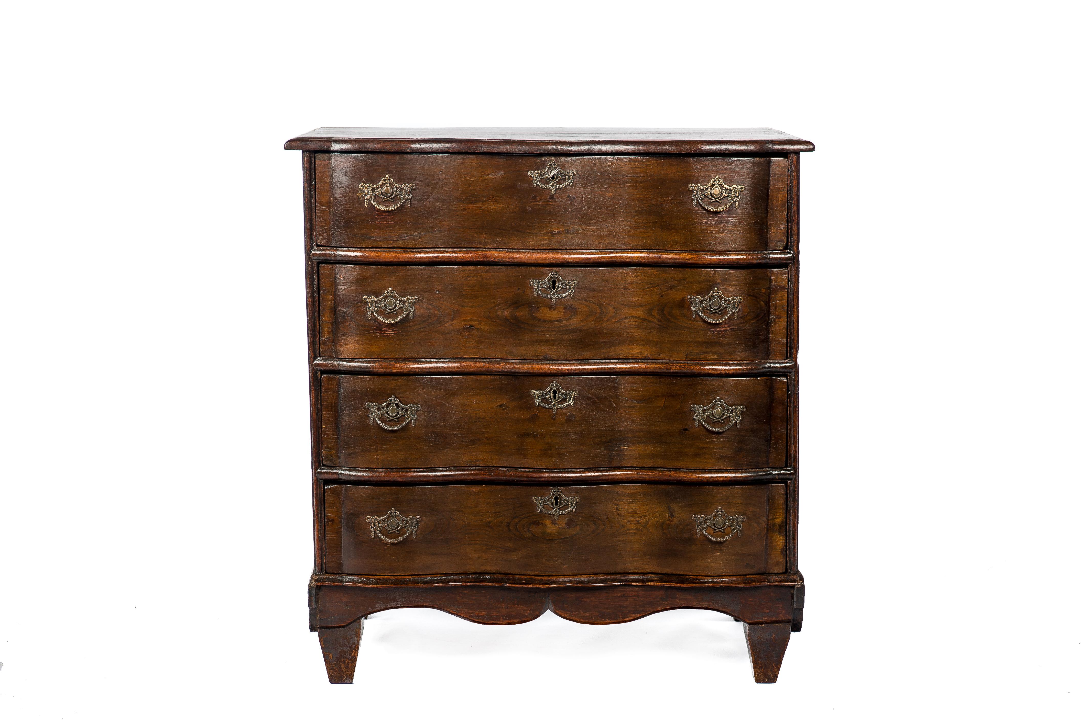This elegant four-drawer commode was made in the Netherlands circa 1860. It was made in solid elm with a pine interior. The commode has a convex-concave curved front. The piece has a two-plank top with a bullnose edge. Below four drawers are