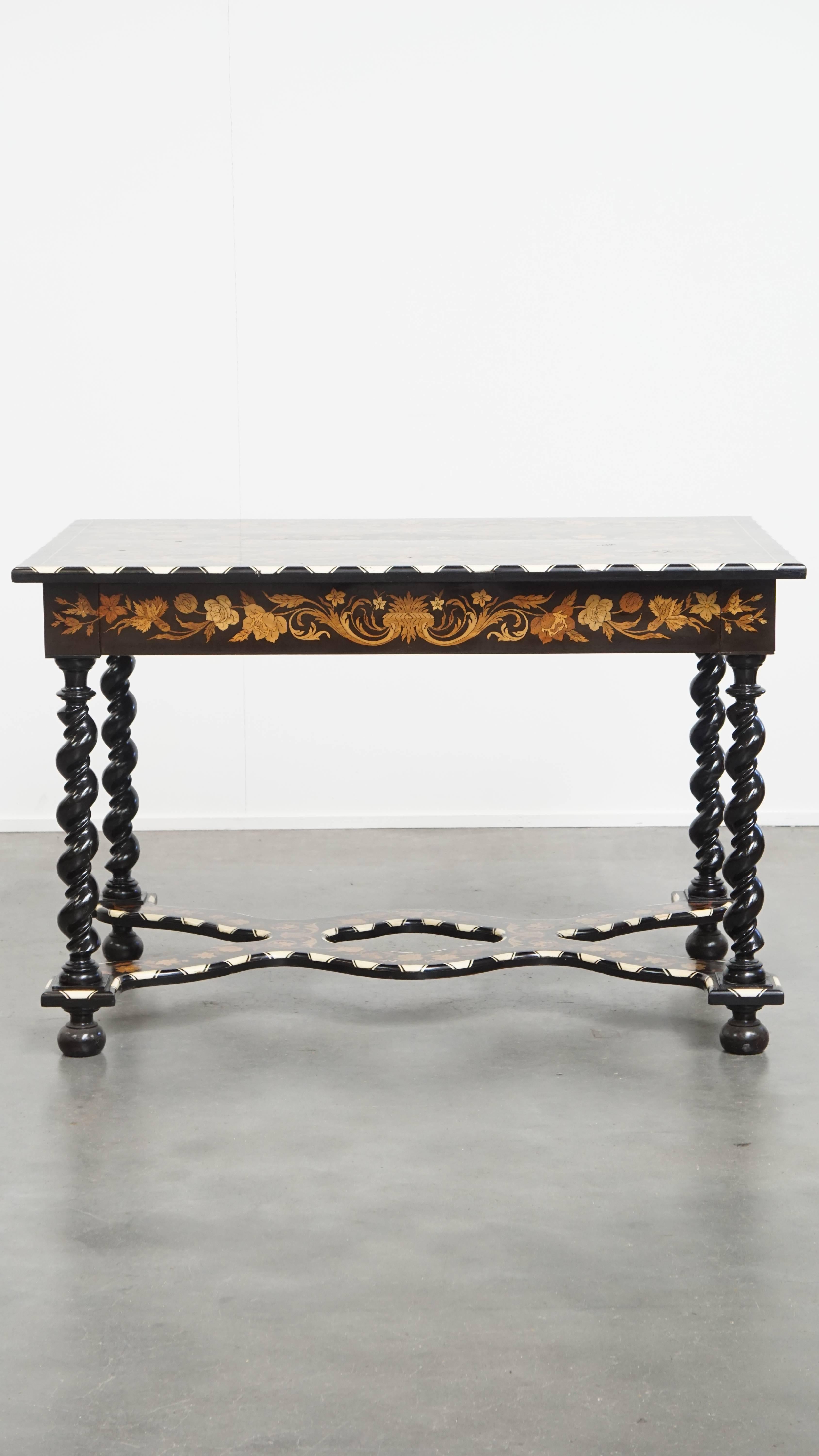 Offered is this beautiful and elegant antique 19th-century Dutch marquetry table — a truly unique and original piece for the enthusiast! 

This antique Dutch table is a real eye-catcher thanks to its graceful appearance, featuring turned legs and
