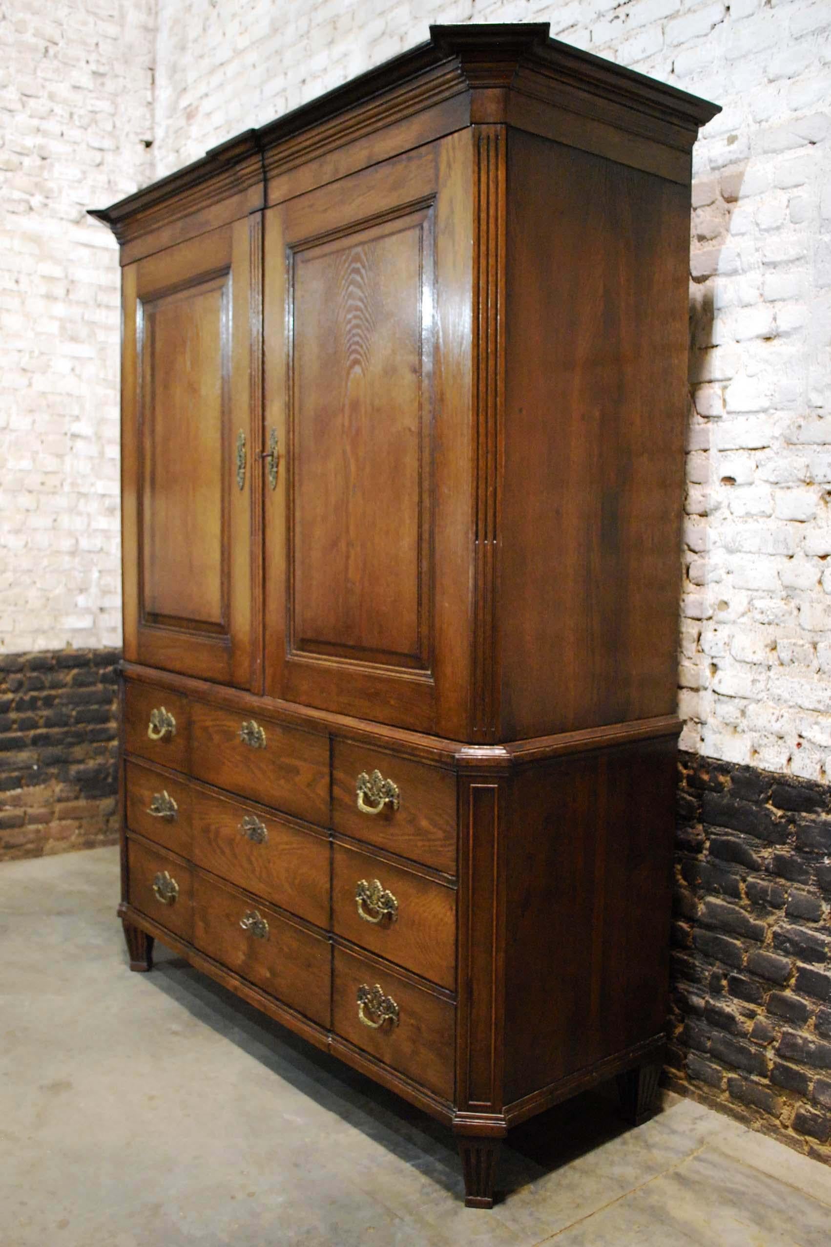 A beautiful Empire style or Louis seize cabinet that was made in the Netherlands, circa 1820s.
This high quality piece is completely made in the finest European oak. There are three stepped drawers in the lower section. The drawers are fitted with