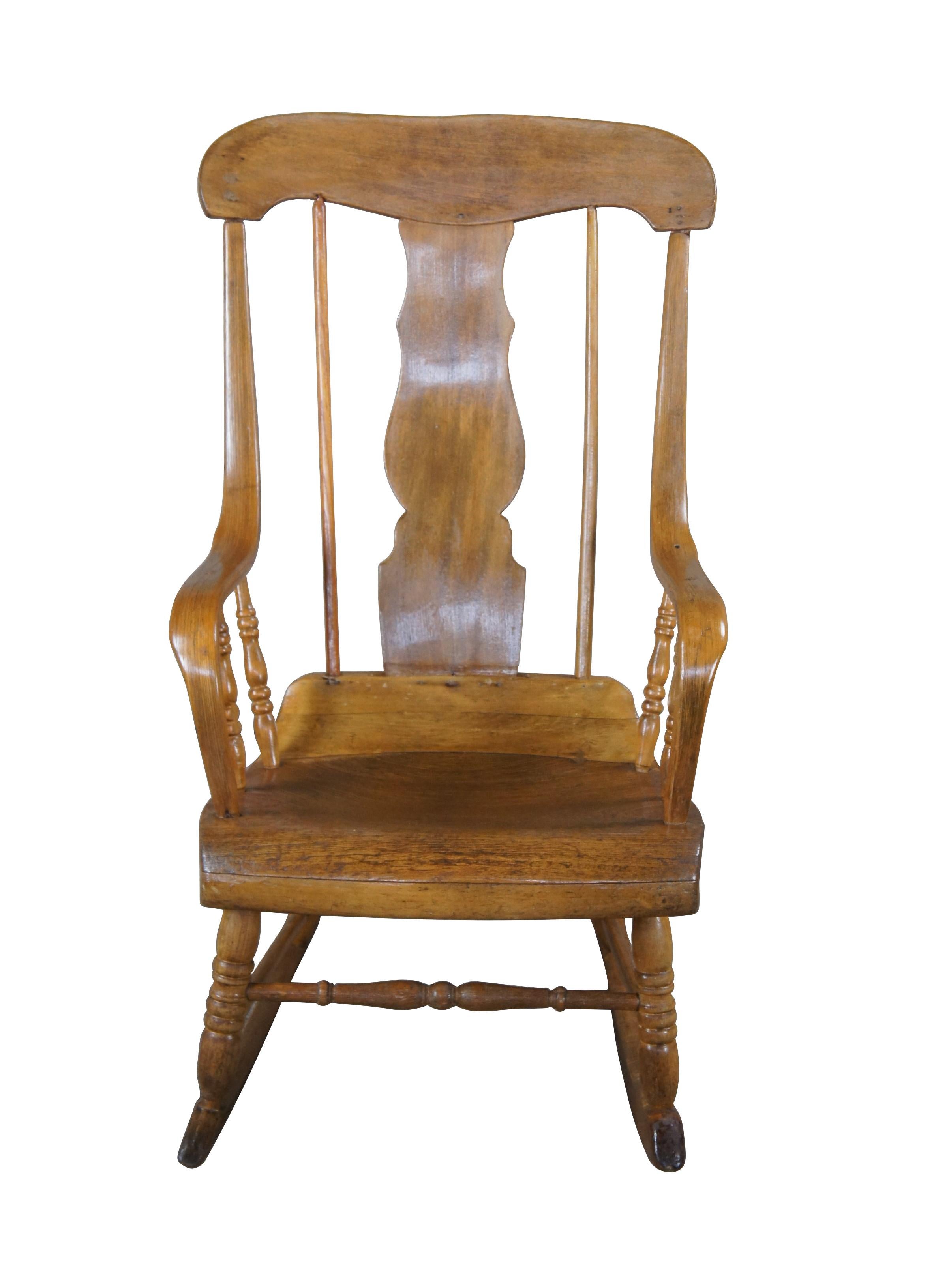 Antique Boston rocker, circa 1850s. Despite the name, Boston rockers were actually made in Connecticut. They have a scrolled seat, spindled splat back, and a rolling headpiece. The Boston rocker was most popular from 1830 to 1890.

Dimensions:
33