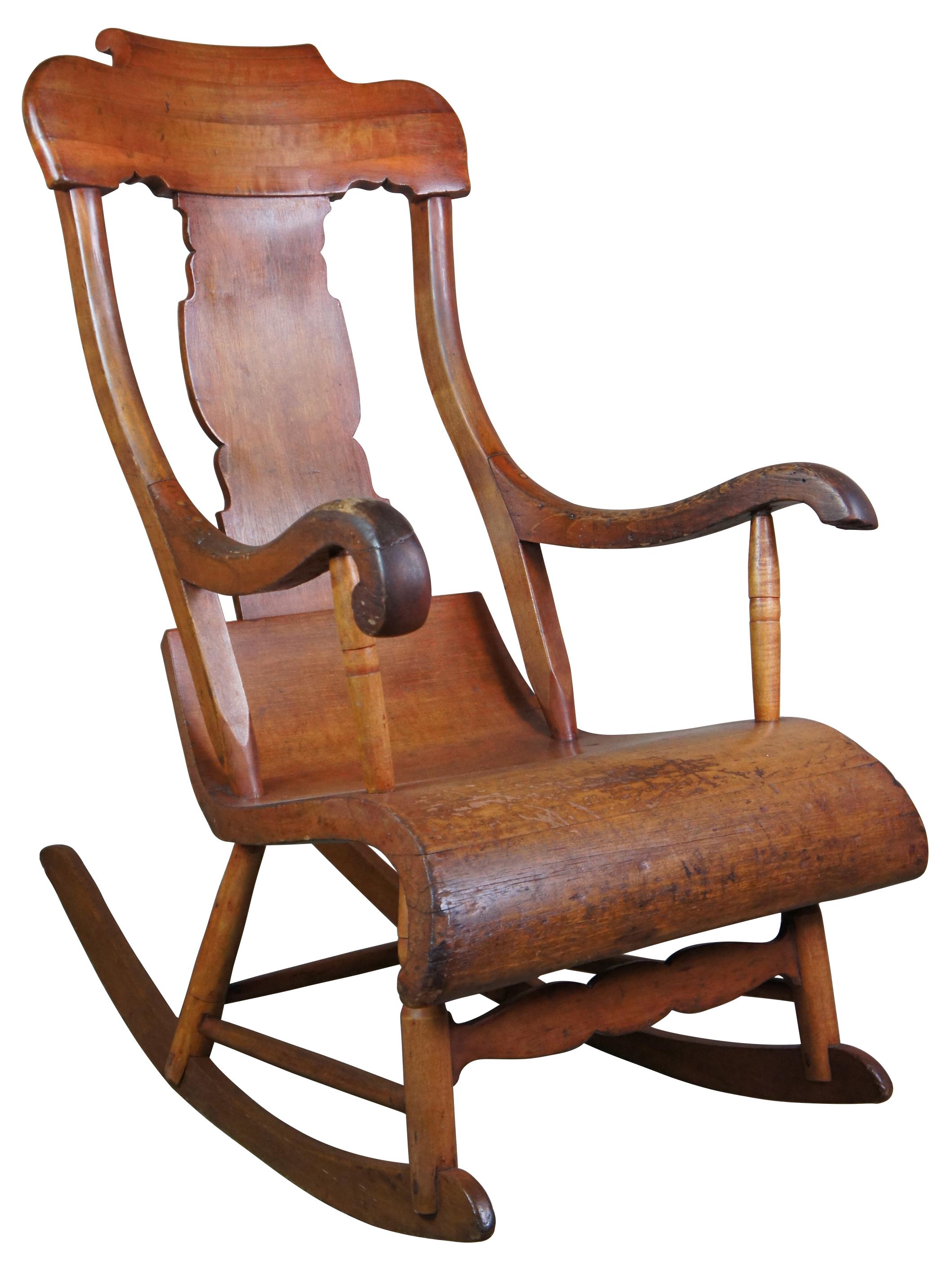 Antique Boston rocker, circa 1850s. Despite the name, Boston rockers were actually made in Connecticut. They have a scrolled seat, spindled back, and a rolling headpiece. The Boston rocker was most popular from 1830 to 1890. Measures: 42