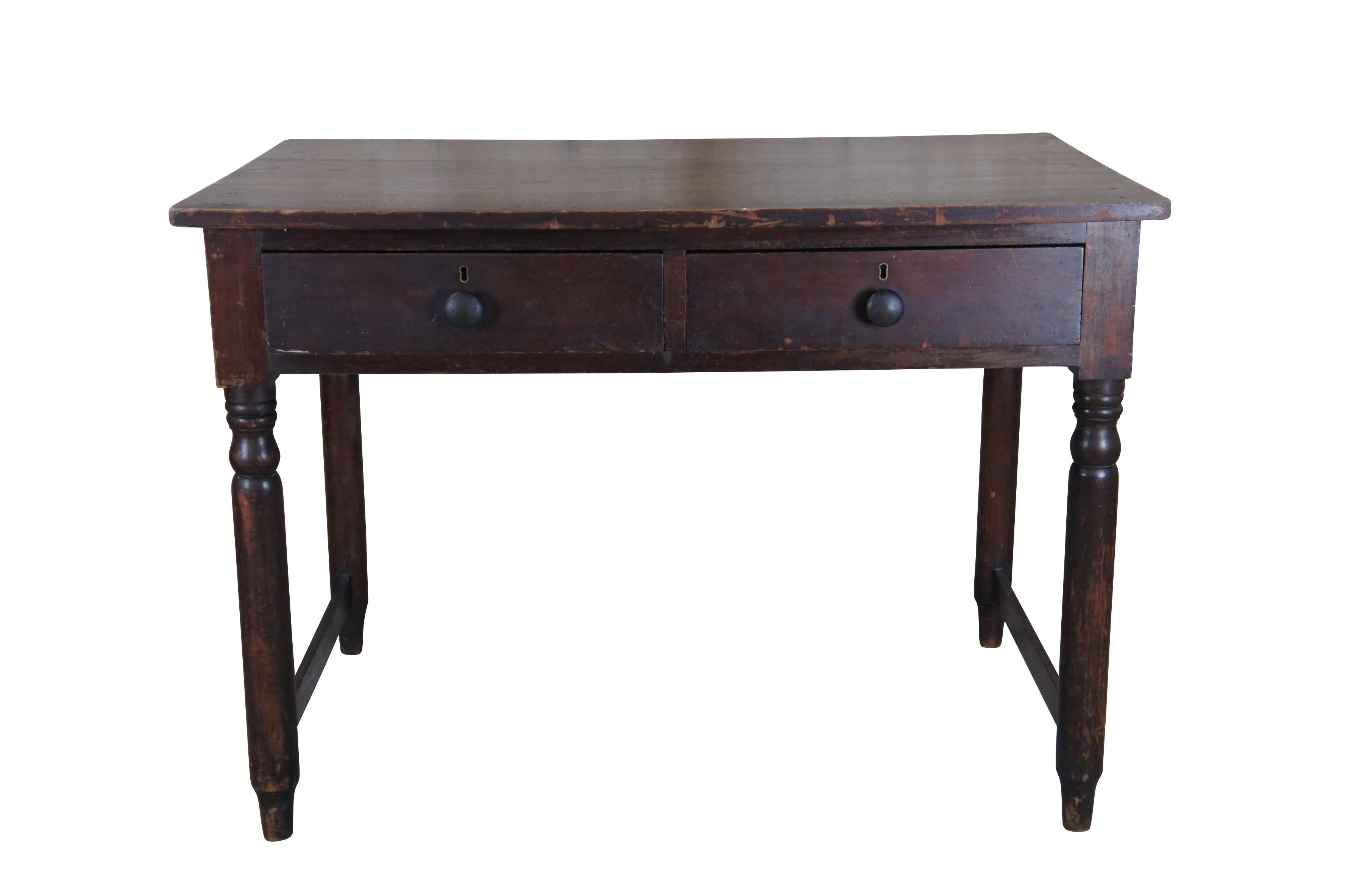 Antique primitive 19th century early American library writing desk.  Made of pine featuring rectangular form with two drawers featuring hand dovetailing, hand cut nails, and turned posts connected by stretcher.

Dimensions: 
43 1/2