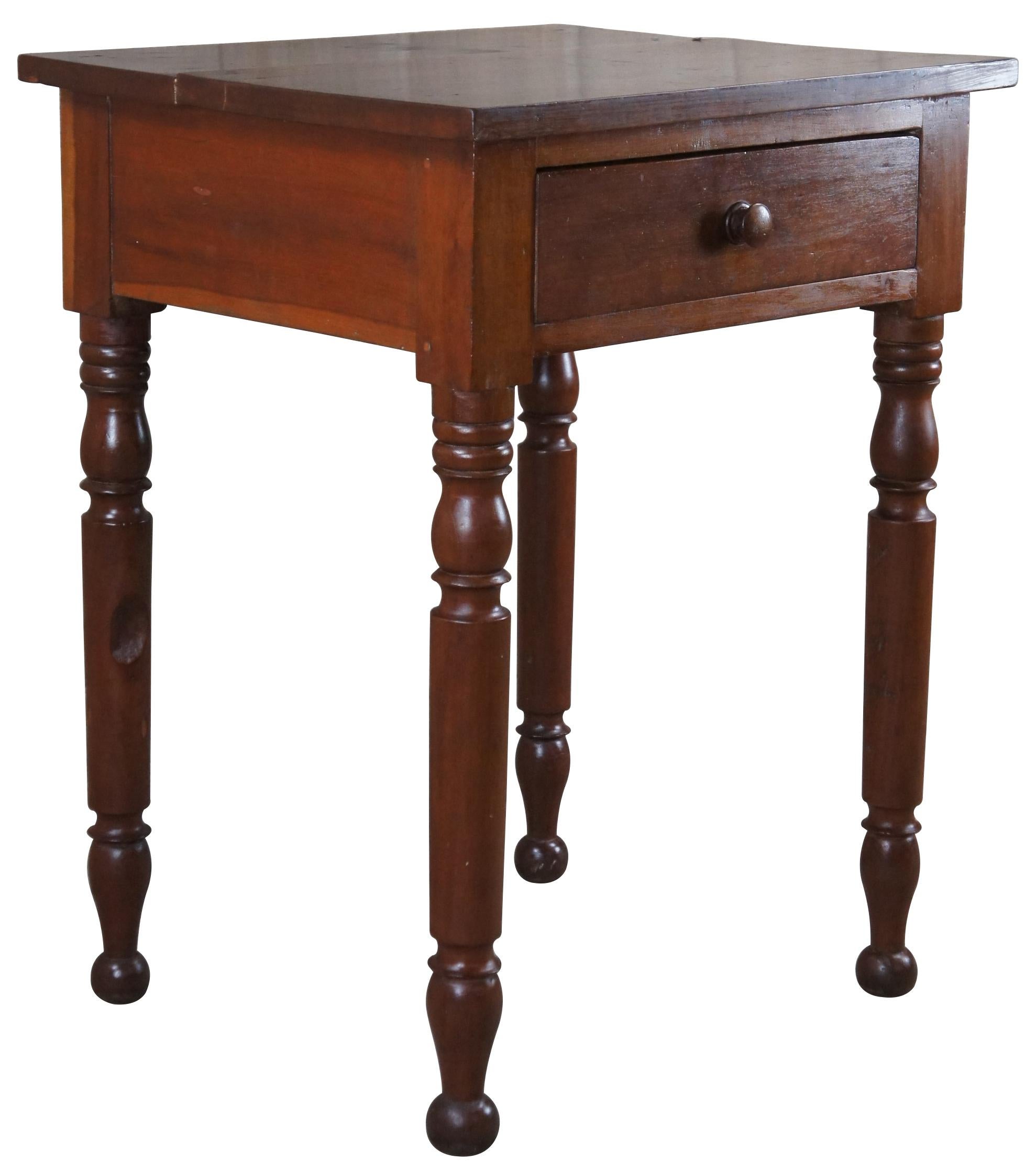 Antique Early American 19th century side table. Made of cherry featuring rectangular form with one drawer, turned legs and hand planing and dovetailing.