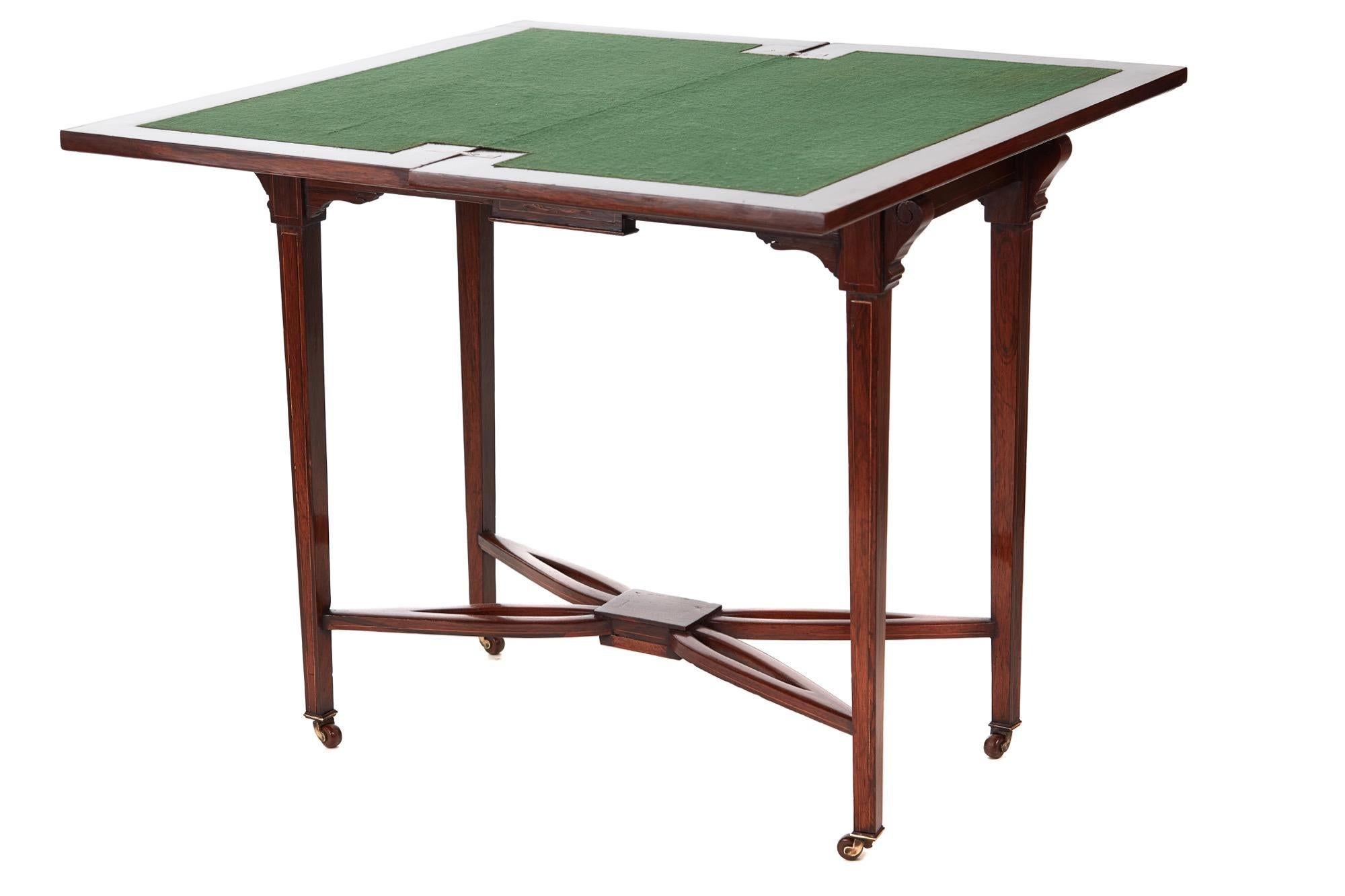 Antique Edwardian Rosewood inlaid freestanding card table with a very attractive ivorine and satinwood inlay. The top swivels to reveal a green baize interior. It boasts a pretty inlaid frieze and is supported by four square inlaid tapering legs