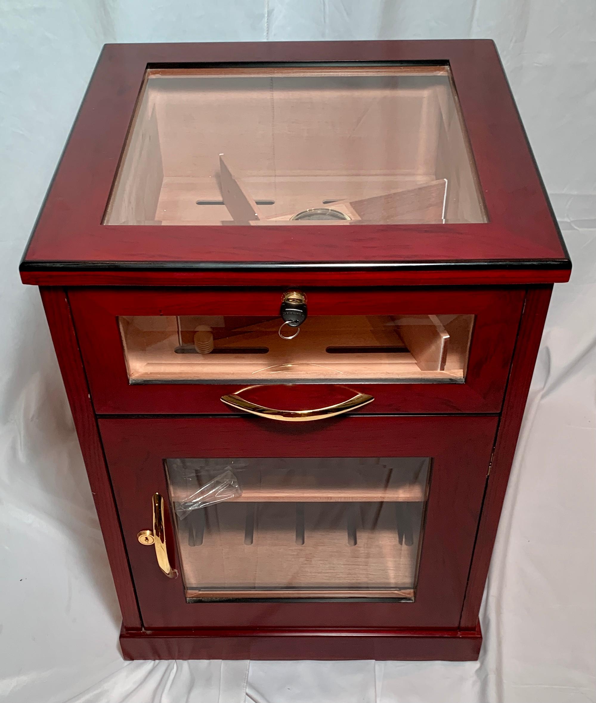 Handsome English beveled glass & brass mounted mahogany humidor.  Beautiful interior, glass top, slide drawer and front door with working lock and key.
