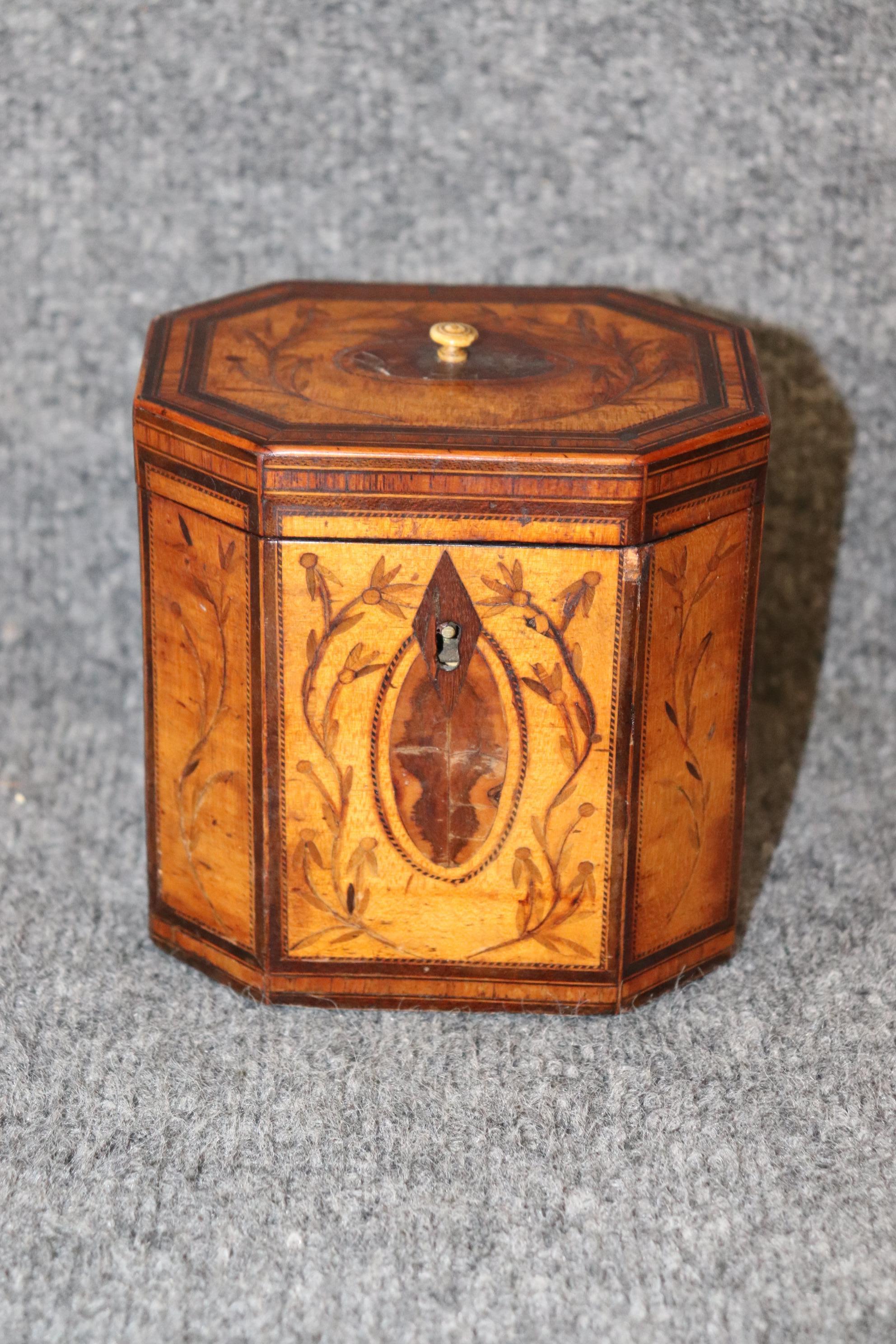 Dimensions- H: 5 1/4in W: 5in D: 4in 
This Antique 19th Century English Edwardian Inlaid Tea Caddy Box is extremely intricate and is great example of 19th century english decor! This tea caddy is equipped with a silver leaf interior as well as