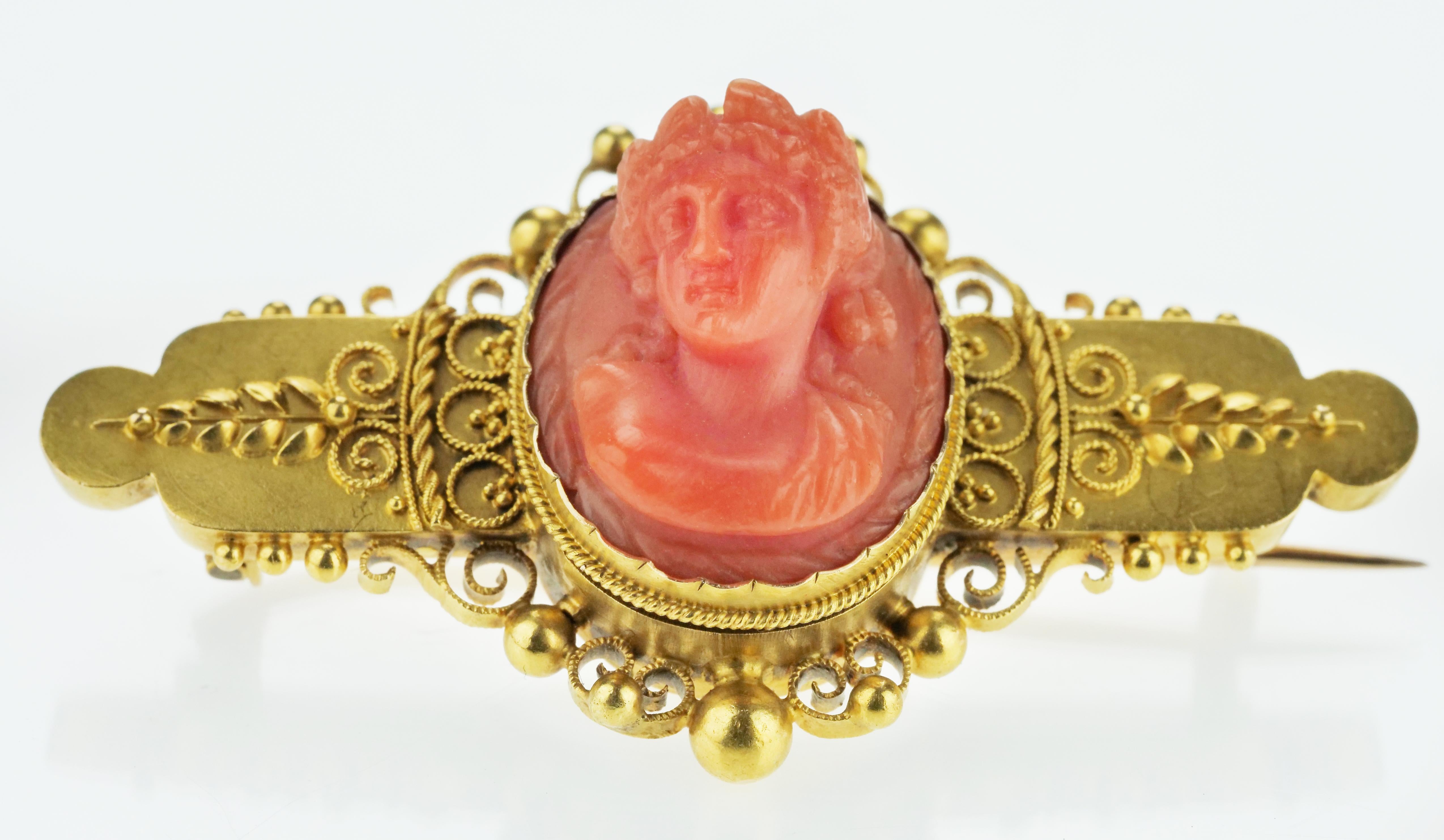 A Victorian 15 carat gold brooch with a finely carved coral cameo, a lovely example of the 19th century Etruscan revival movement. Hallmarked in Birmingham, England in 1896, this is an exceptional example of the craftsmanship which thrived in the