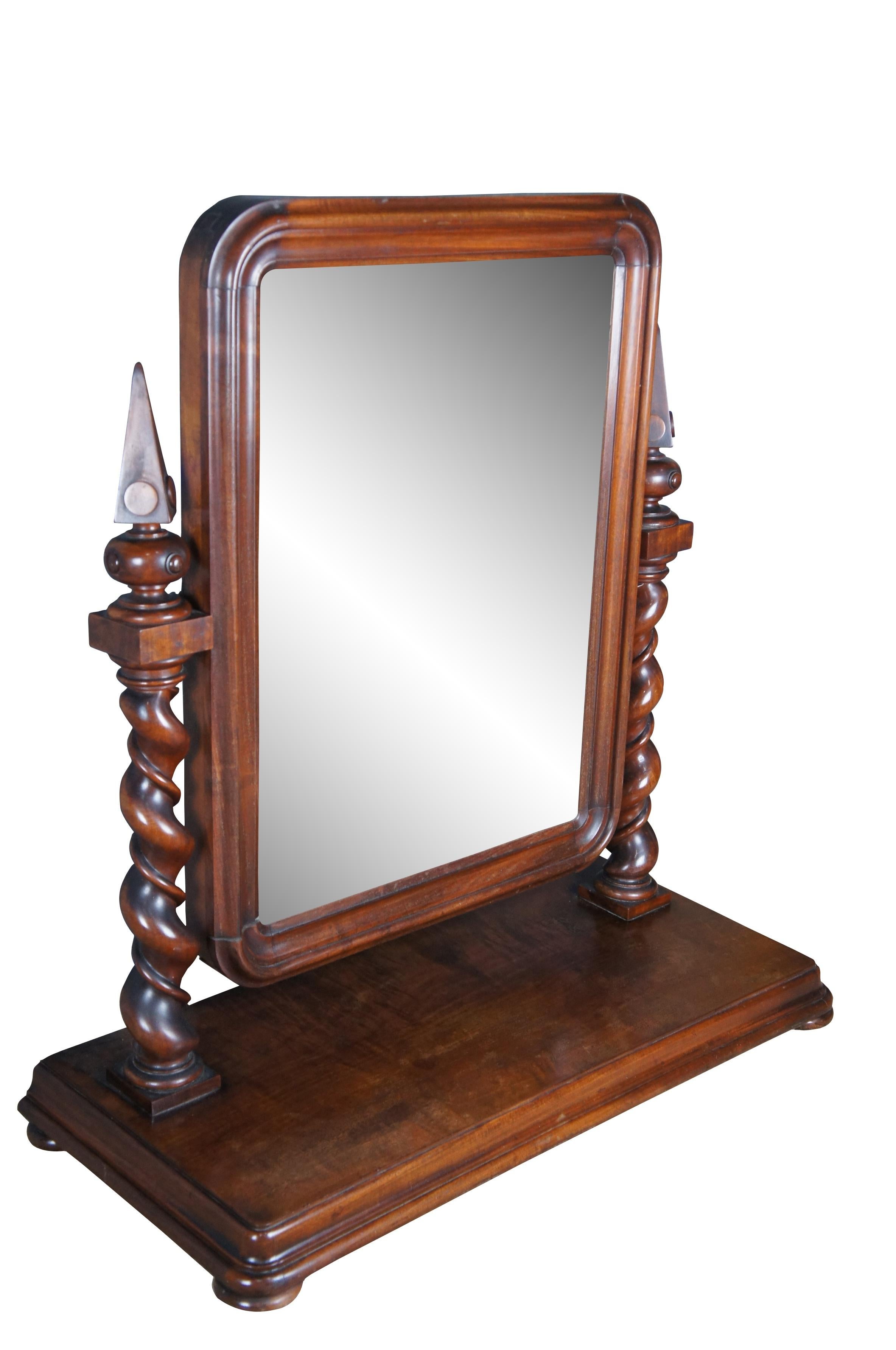 Impressive antique 19th century (circa 1880s) English Empire gentleman's dressing mirror. Made from mahogany with a beveled wooden frame supported by exceptional barley twist uprights with pyramid shaped finials. The rectangular base is raised over