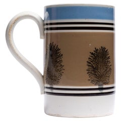 Taza inglesa antigua de mochaware del siglo XIX