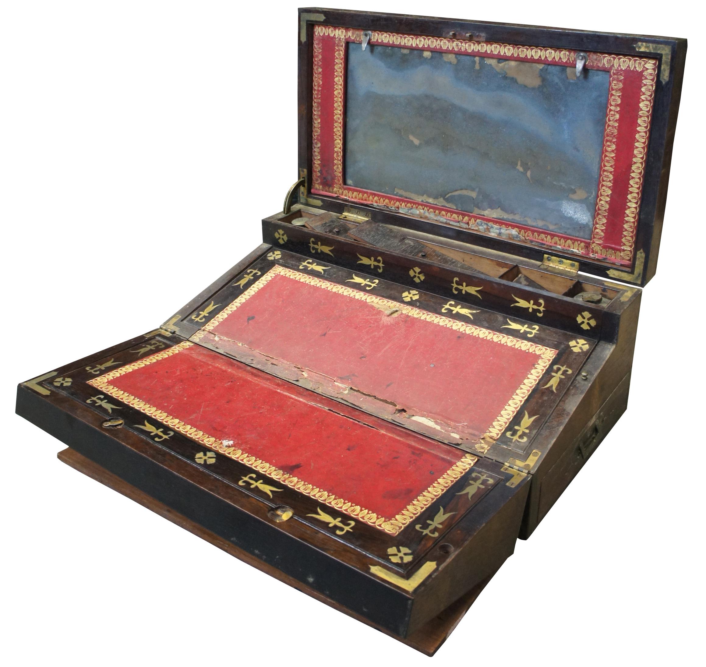 Antique early 19th century writing slope/storage chest, made of wood with brass hardware and inlays, mirror, bonded leather writing surfaces, two glass inkwells, and one semi-concealed drawer in the side, which locks with a brass pin.
   