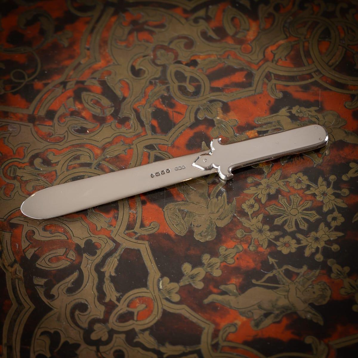 Antique 20th Century English solid silver paperknife bookmark. Hidden within the handle, a small retractable penknife is present. Hallmarked English solid silver (925 standard), London, year 1868 (u), Maker's mark HWD (Henry William