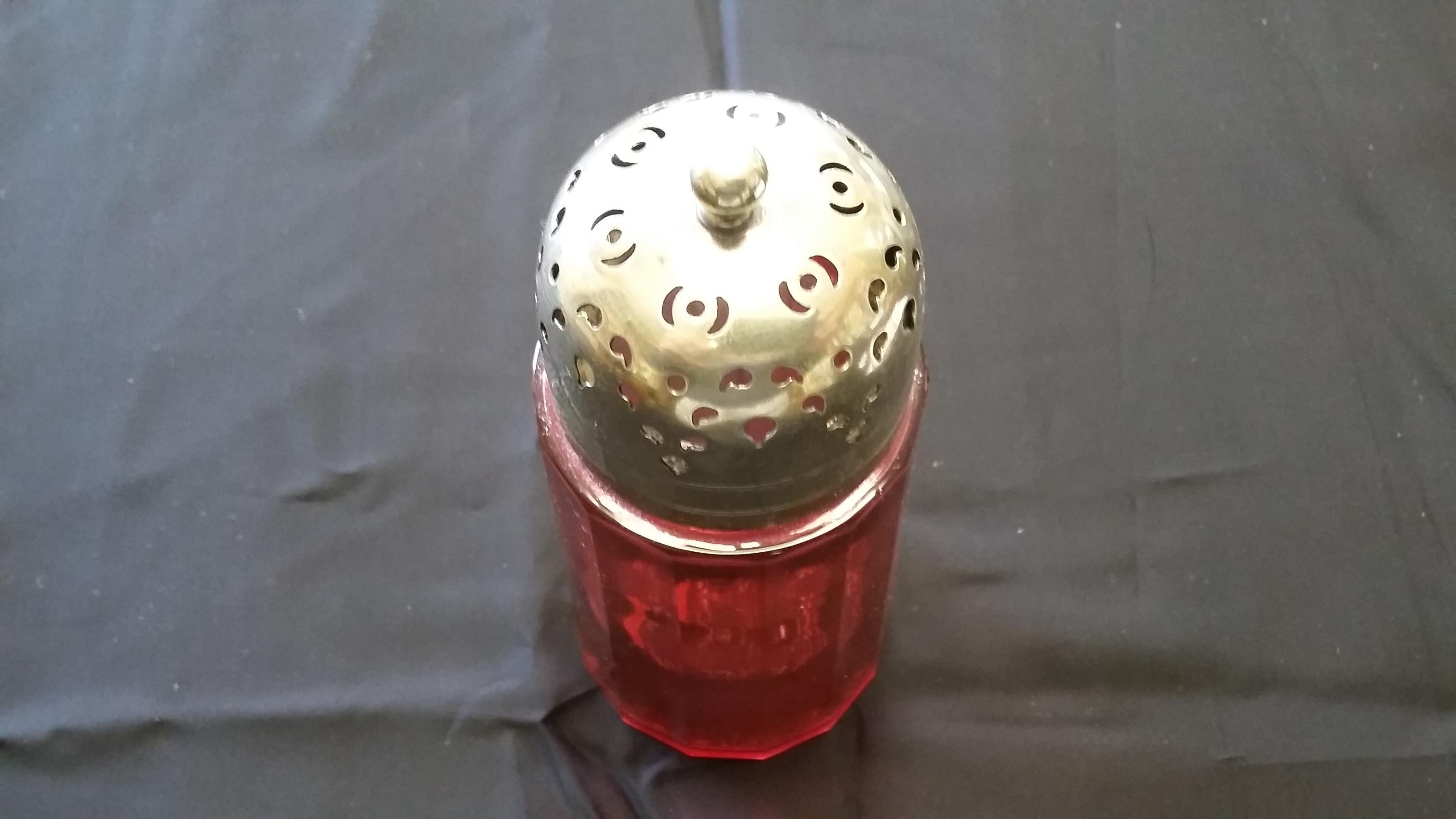 Unique 19th century English sugar shaker. Made of cranberry glass with a silver-plated top. Glass is tapered and beveled. Top is signed EPNS.